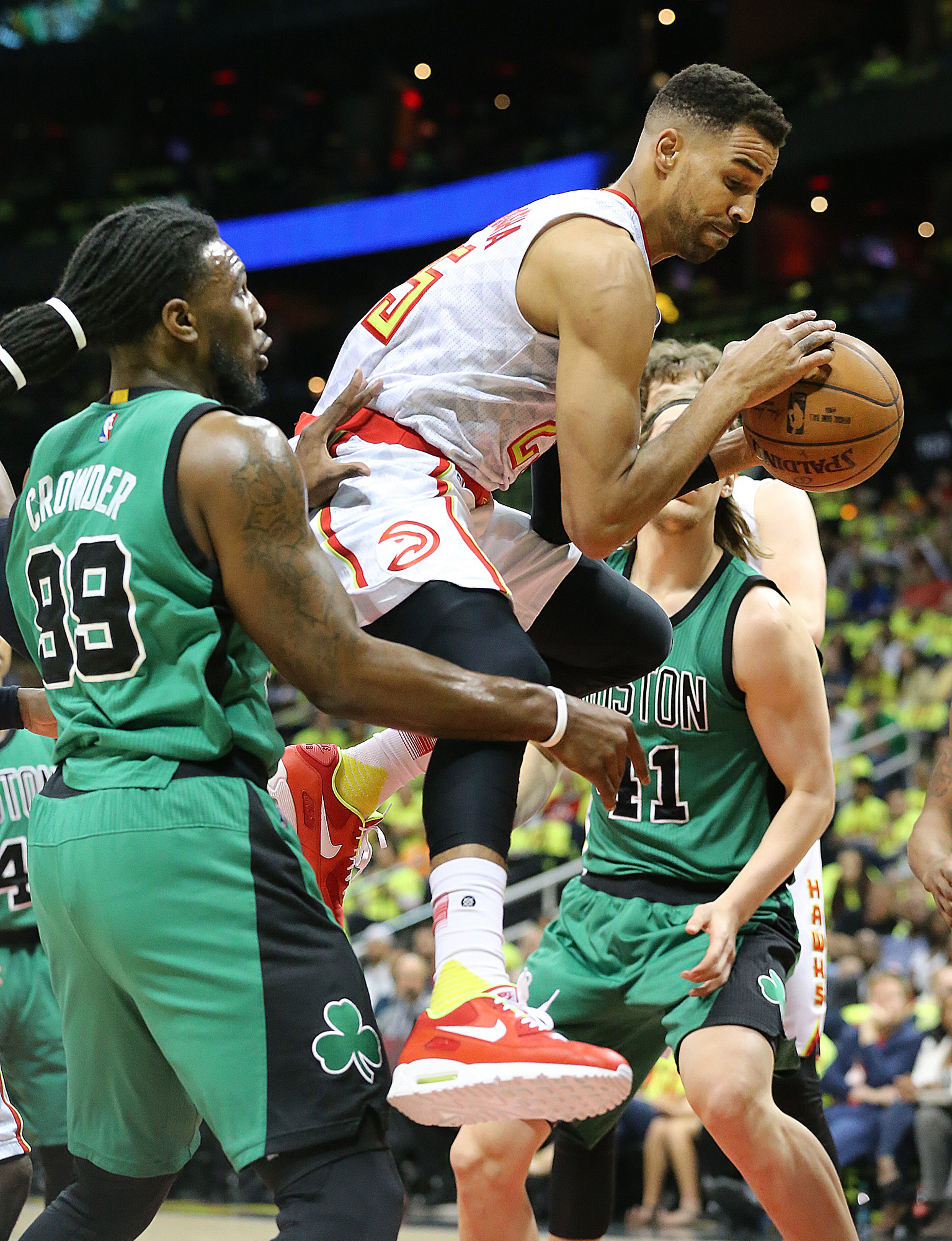 041616 ATLANTA: Hawks Thabo Sefolosha grabs an offensive rebound past Celtics forward Jae Crowder in their first NBA Eastern Conference first round playoff game at Philips Arena on Saturday, April 16, 2016. Curtis Compton / ccompton@ajc.com