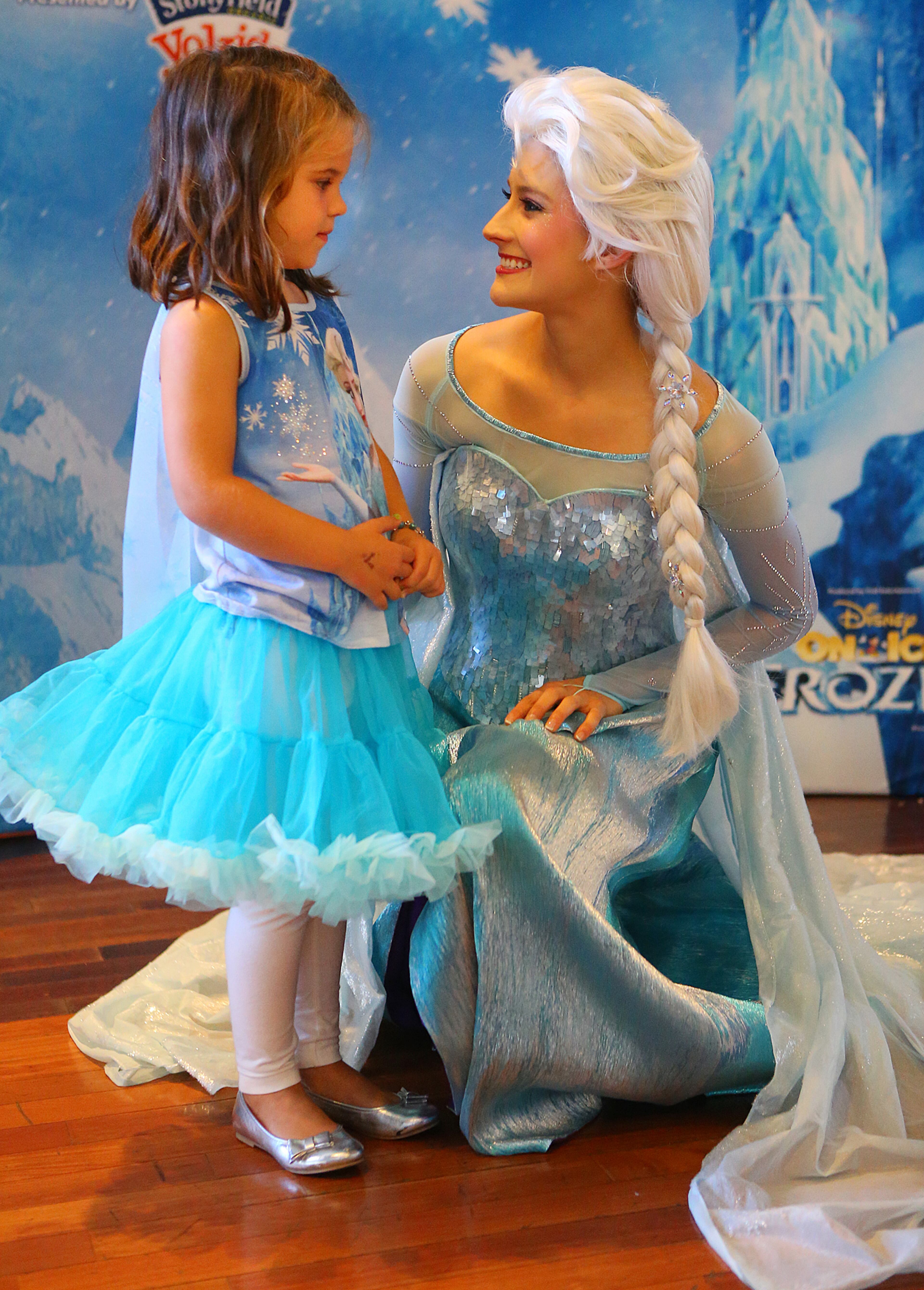 Dressed like her idol Celie Crawford, 5, Marietta, meets royal princess Elsa during the meet and greet/blue carpet for Disney On Ice presents Frozen at Philips Arena on Wednesday, Oct. 8, 2014, in Atlanta.