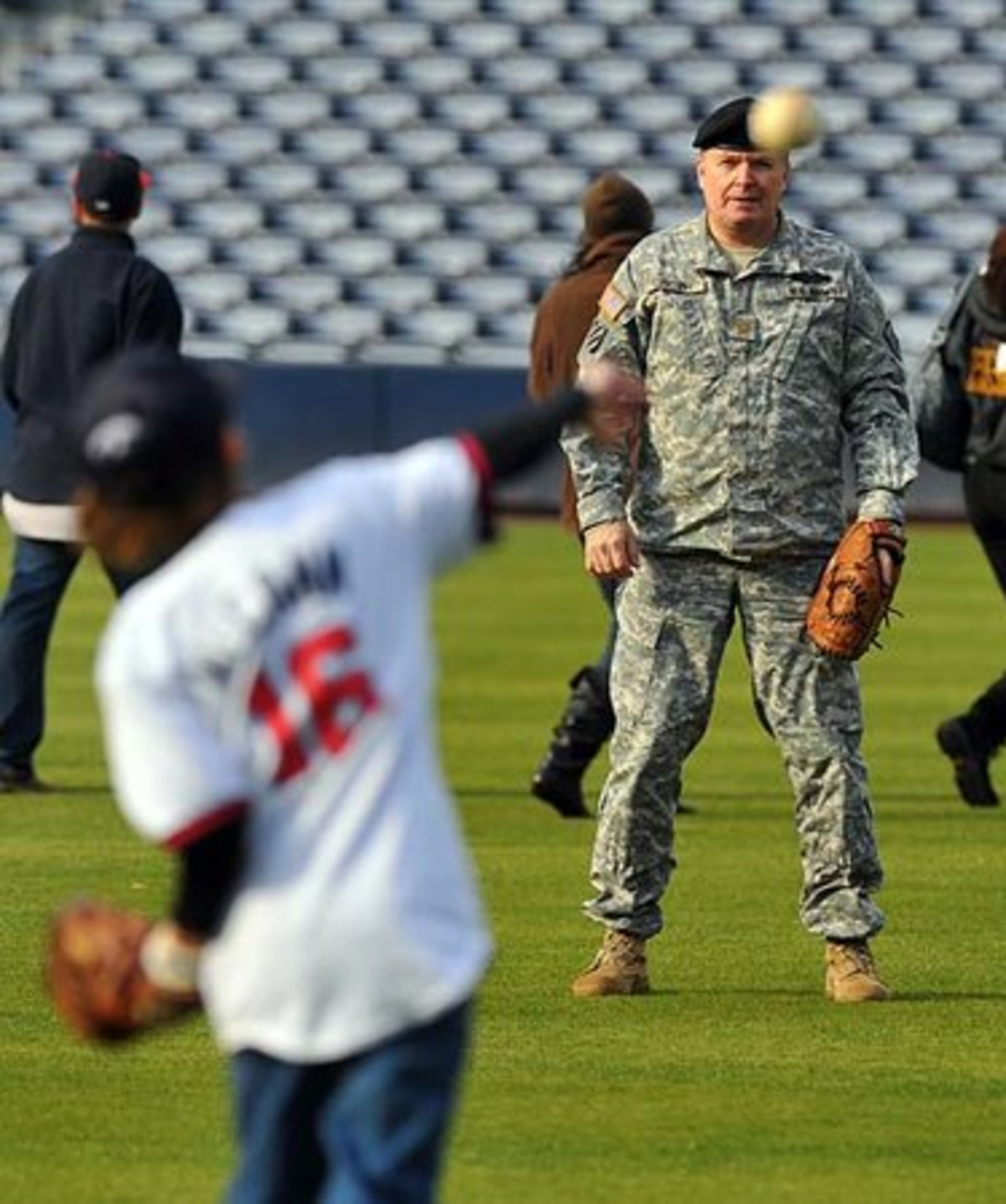 Major John "Skip" Groth with the Georgia Army National Guard plays catch at Turner Field with his son Matthew, 11. Members of the Atlanta Braves coaching staff met with members of the military and their families.