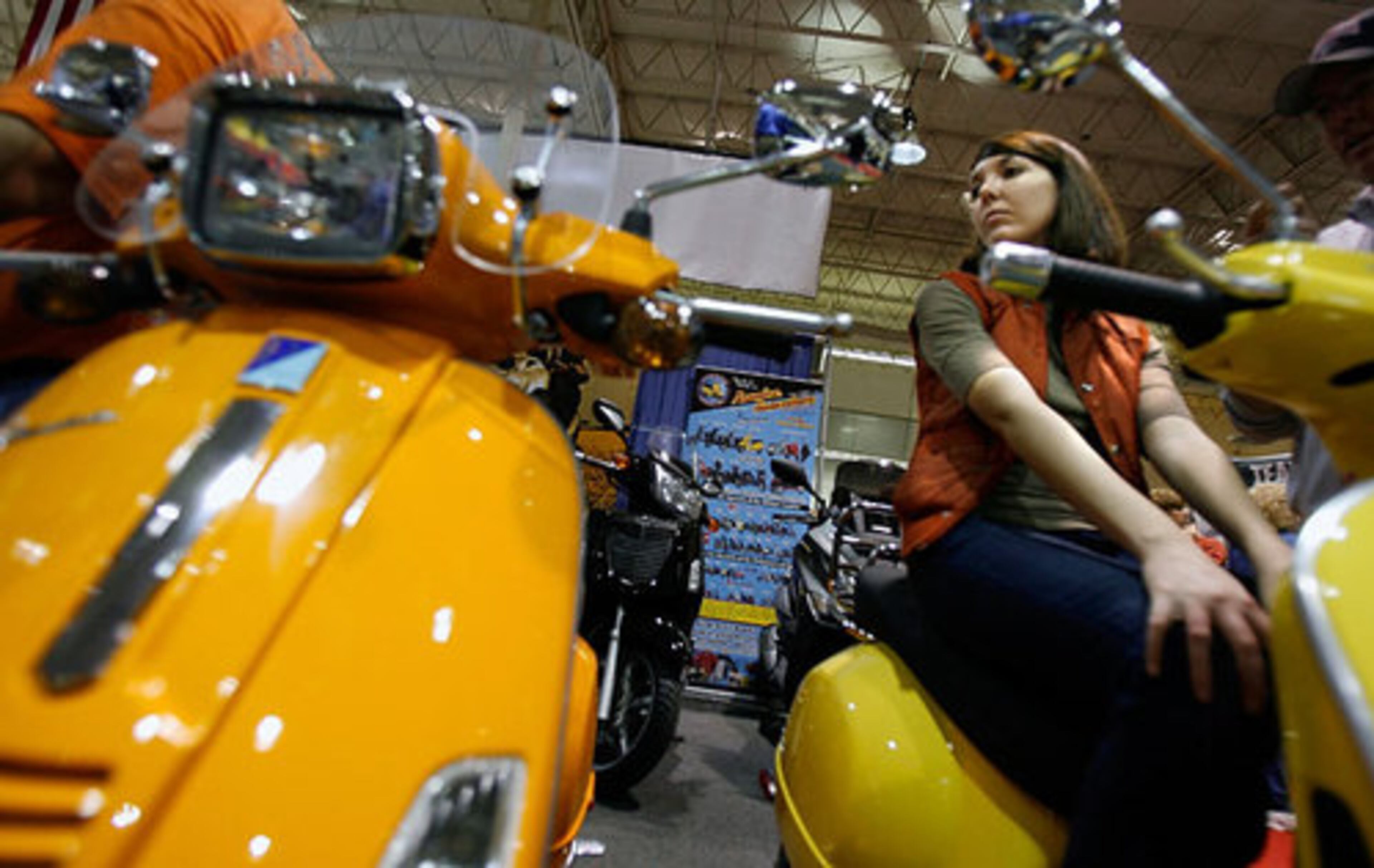 Lacie Travis, 24, of Flowery Branch, eyes an orange Vespa that she's hoping to buy by the end of the year.