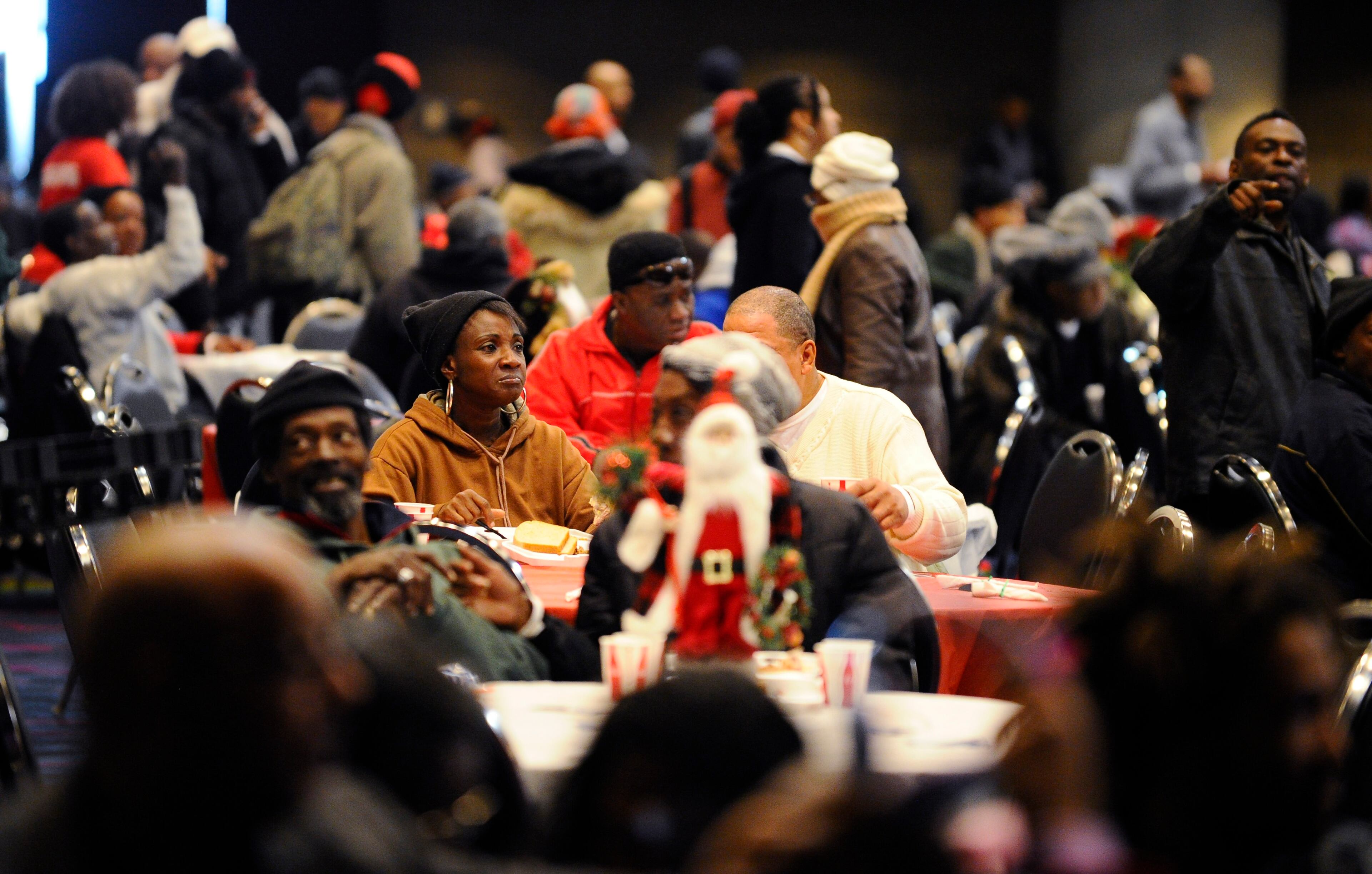 Some of the more than 5,000 homeless people expected for the annual Hosea Feed the Homeless Christmas dinner sit down to eat a hot meal at the Georgia World Congress Center on Thursday, Dec. 25, 2014, in Atlanta. David Tulis/AJC SpecialAtlanta Holiday Guide 2015: Holiday food and drink