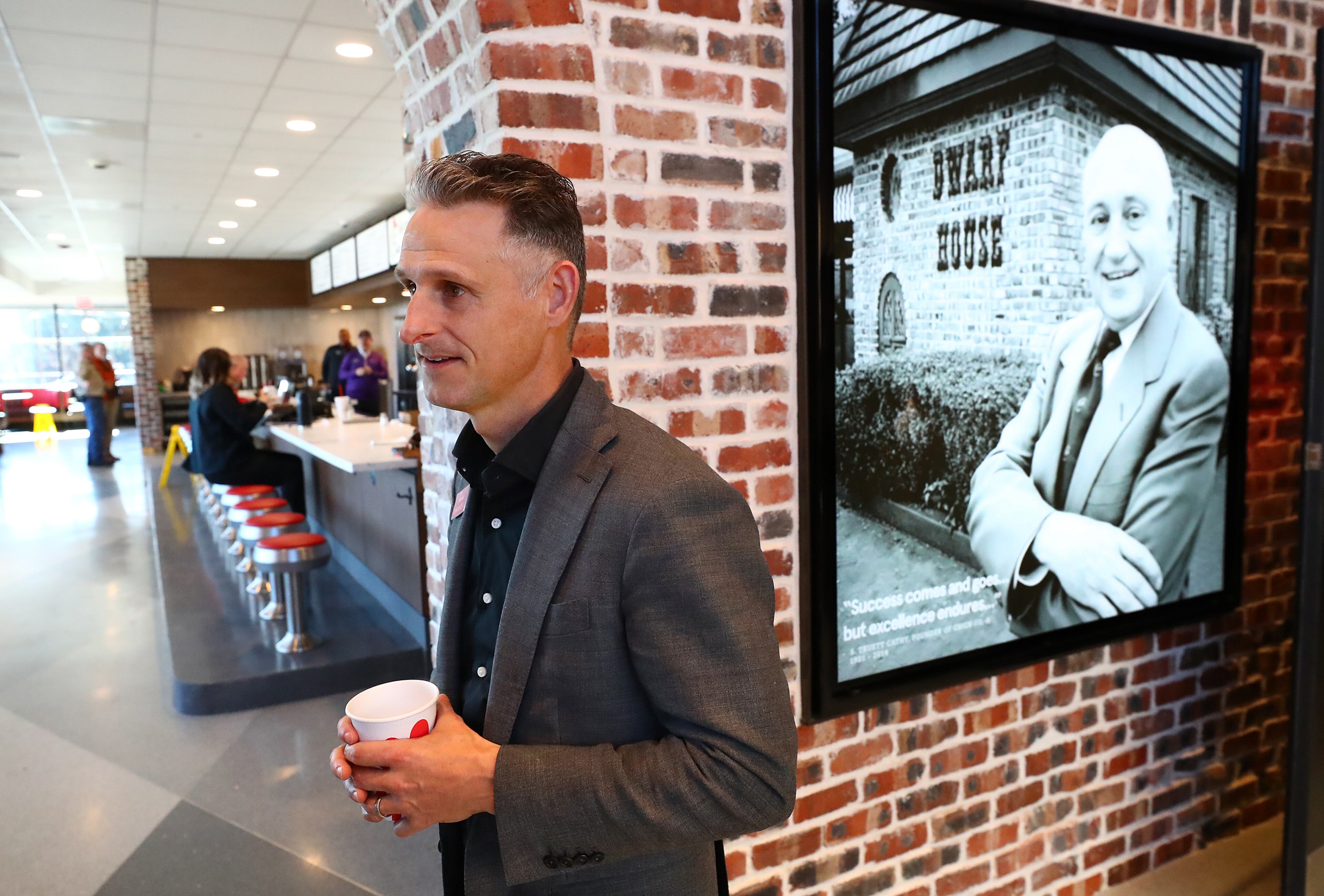021422 Hapeville: John White IV, grandson of S. Truett Cathy, gives a tour of the newly renovated Dwarf House, the first of Truett Cathey’s restaurants, on Monday, Feb. 14, 2022, in Hapeville. Even the original bricks from the 1967 building have been reused. “Curtis Compton / Curtis.Compton@ajc.com”`