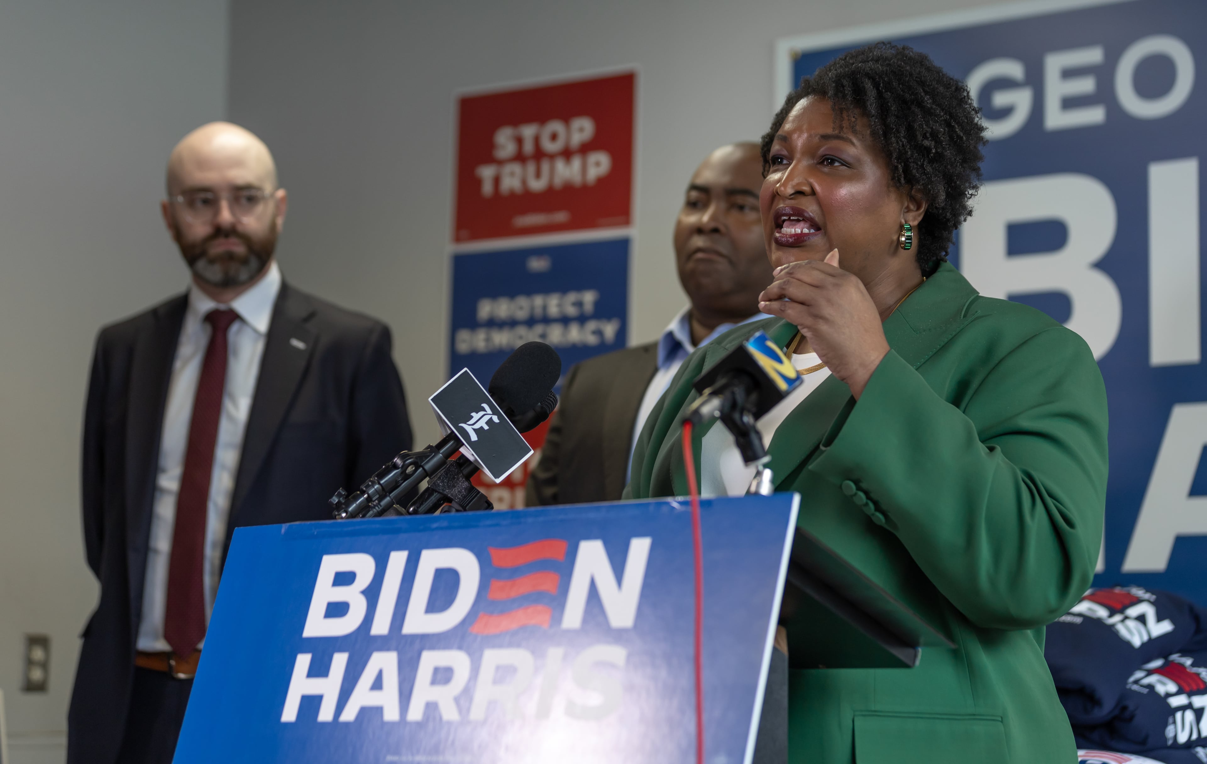 Democratic state Senator, Josh McLaurin, left, and Democratic National Committee Chair Jaime Harrison listen to Stacey Abrams during a press conference following President Joe Biden's debate with former President Donald Trump. Biden's performance at that debate spurred a high-pressure campaign urging him to end his reelection bid. (John Spink/AJC)