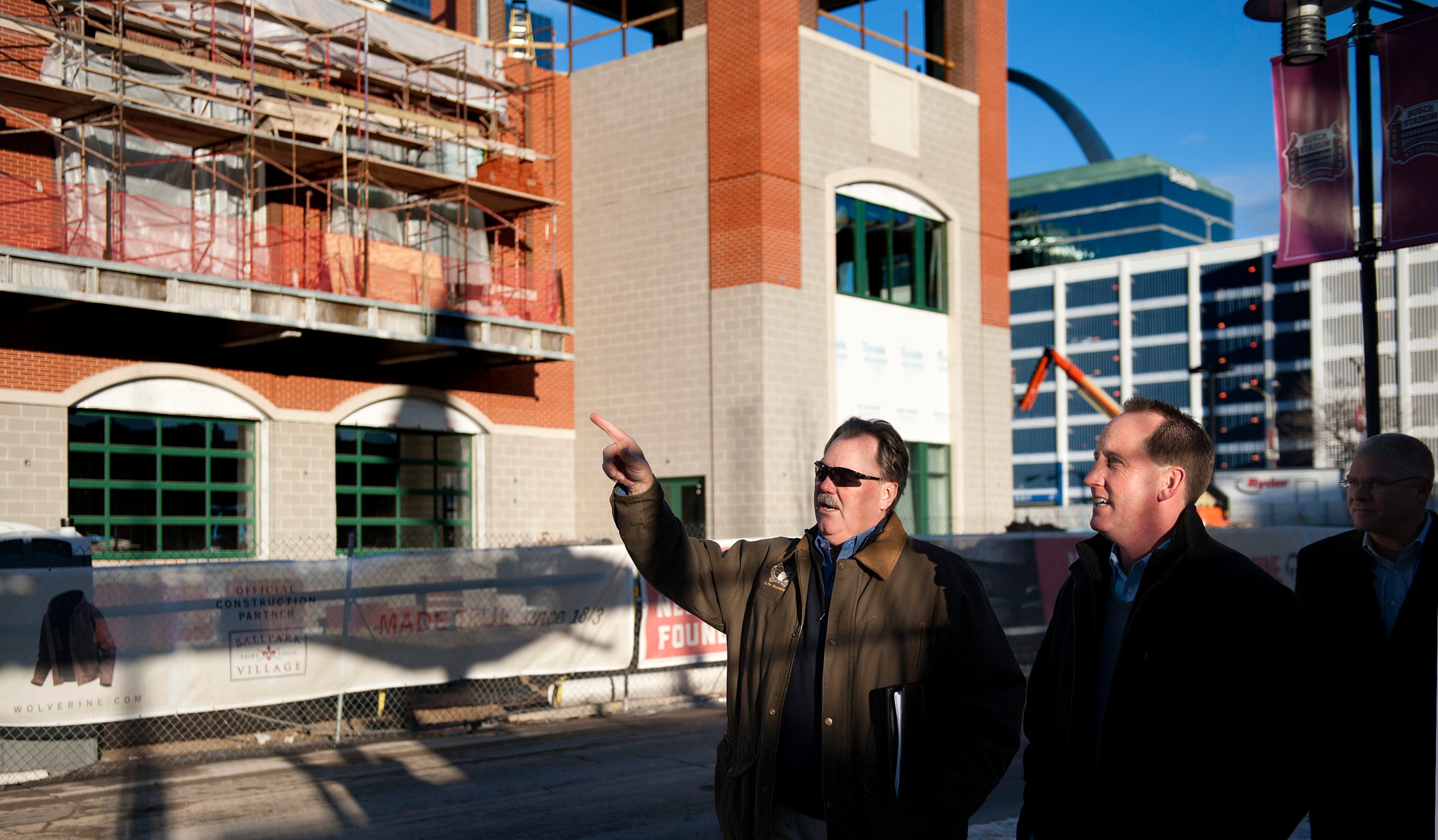 17 DEC. 2013 -- ST. LOUIS -- Atlanta Braves Executive Vice President of Business Operations Mike Plant (left) talks with St. Louis Cardinals Vice President of Corporate Sales and Marketing Thane Van Breusegen while walking along Clark Street in St. Louis Tuesday, Dec. 17, 2013. The street separates Busch Stadium, home of the St. Louis Cardinals, from Ballpark Village, a retail and entertainment development currently under construction as a partnership the Cardinals and the Cordish Companies. The development is slated to open in phases beginning in March 2014 after several years of delays. Photo by Sid Hastings.