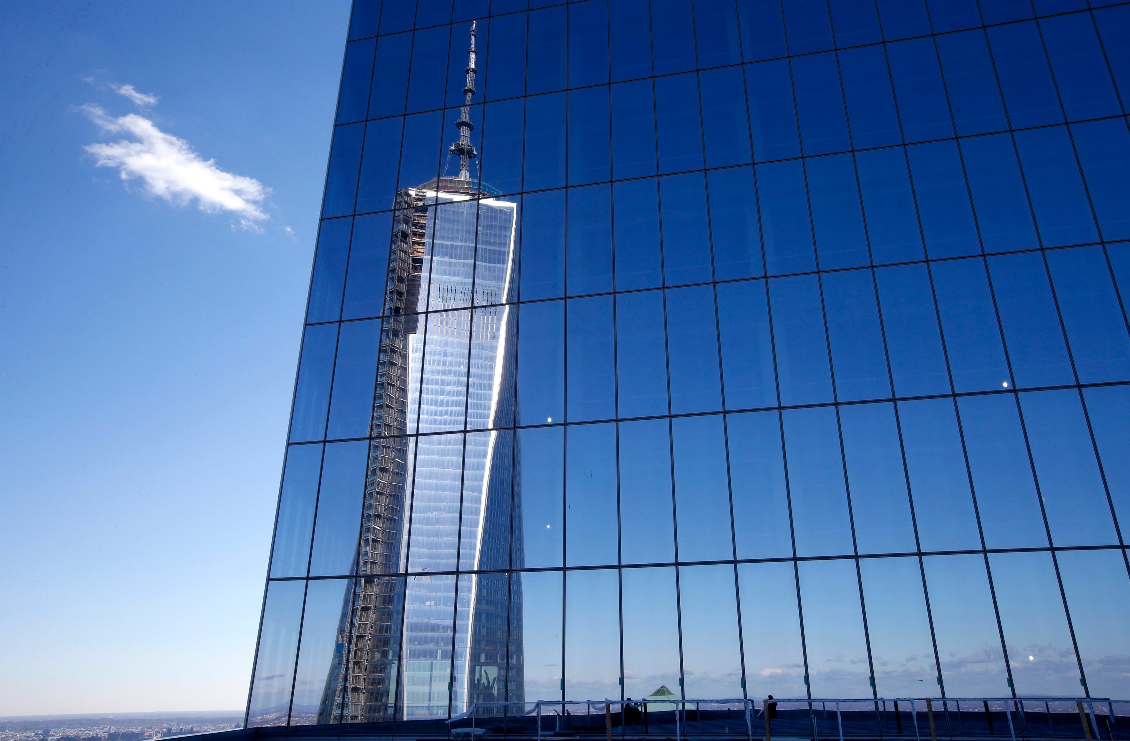 A reflection of the One World Trade Center tower is seen from a terrace on the 57th floor of the soon to be opened 4 World Trade Center tower in New York, November 8, 2013. 4 World Trade center sits at the south east corner of the World Trade Center site and will be the second tower to open on the site since the 2001 attacks on the World Trade Center. REUTERS/Mike Segar (UNITED STATES - Tags: BUSINESS CITYSCAPE TPX IMAGES OF THE DAY)