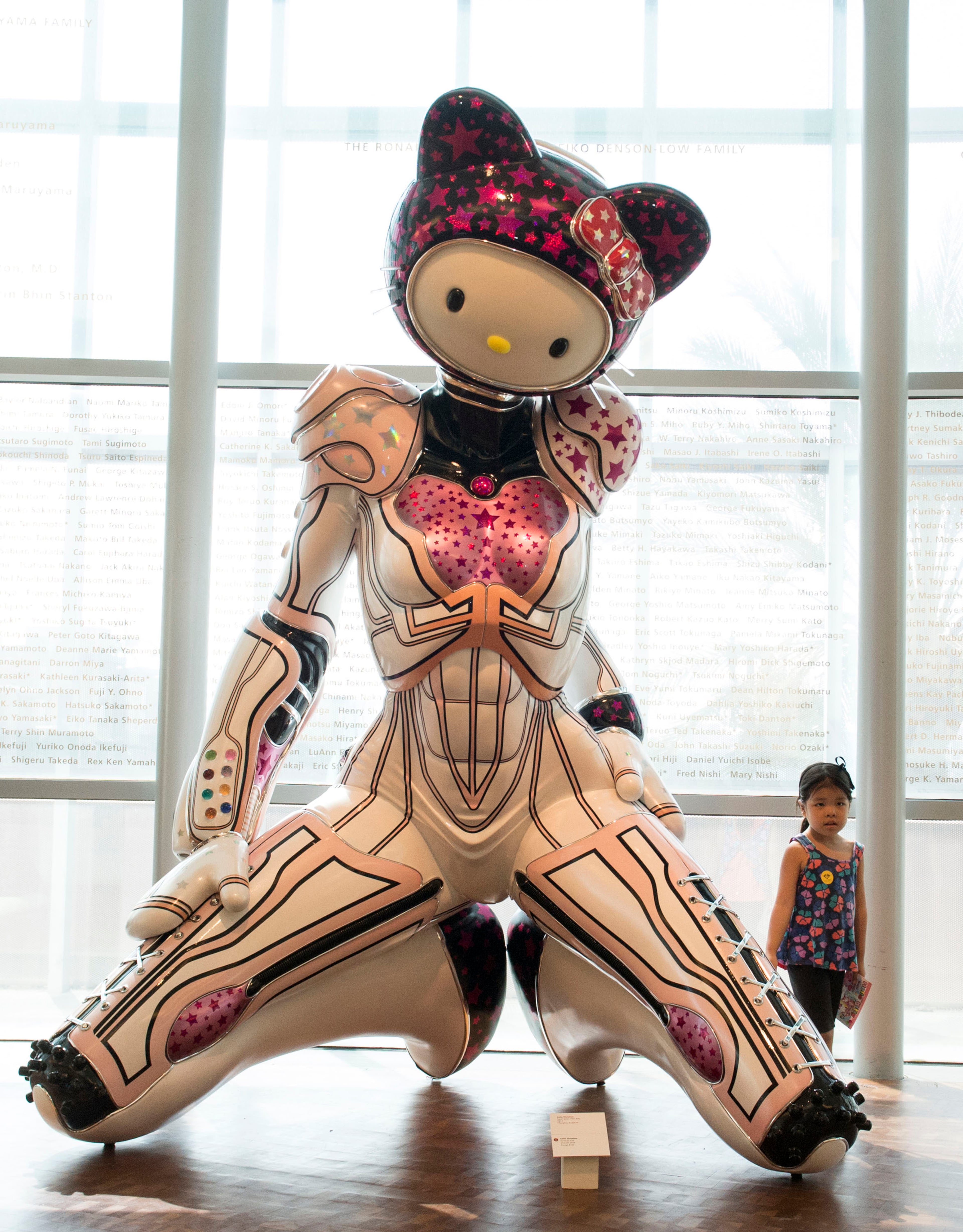 Abby Tanabe, 6, stands next to a fiberglass sculpture by Colin Christian called Super Space Titan Kitty as her mother Joelle takes a photograph at the Japanese American National Museum in Los Angeles on October 10, 2014. (Ed Crisostomo/Orange County Register/MCT)