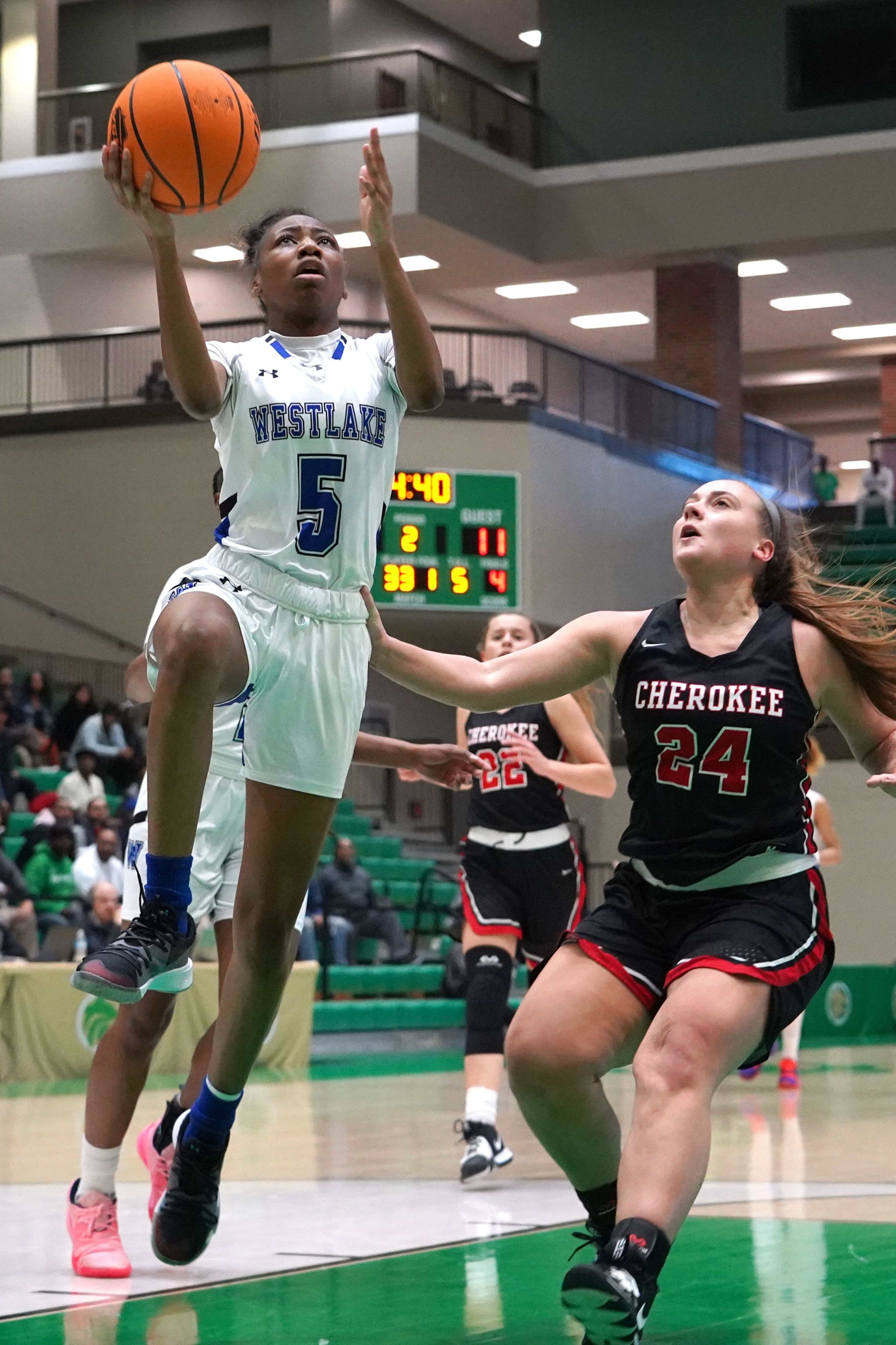 Westlake guard Carlyse Hooks (5) goes up for a layup as Cherokee's Courtney Cates defends. (AP Photo/Tami Chappell)