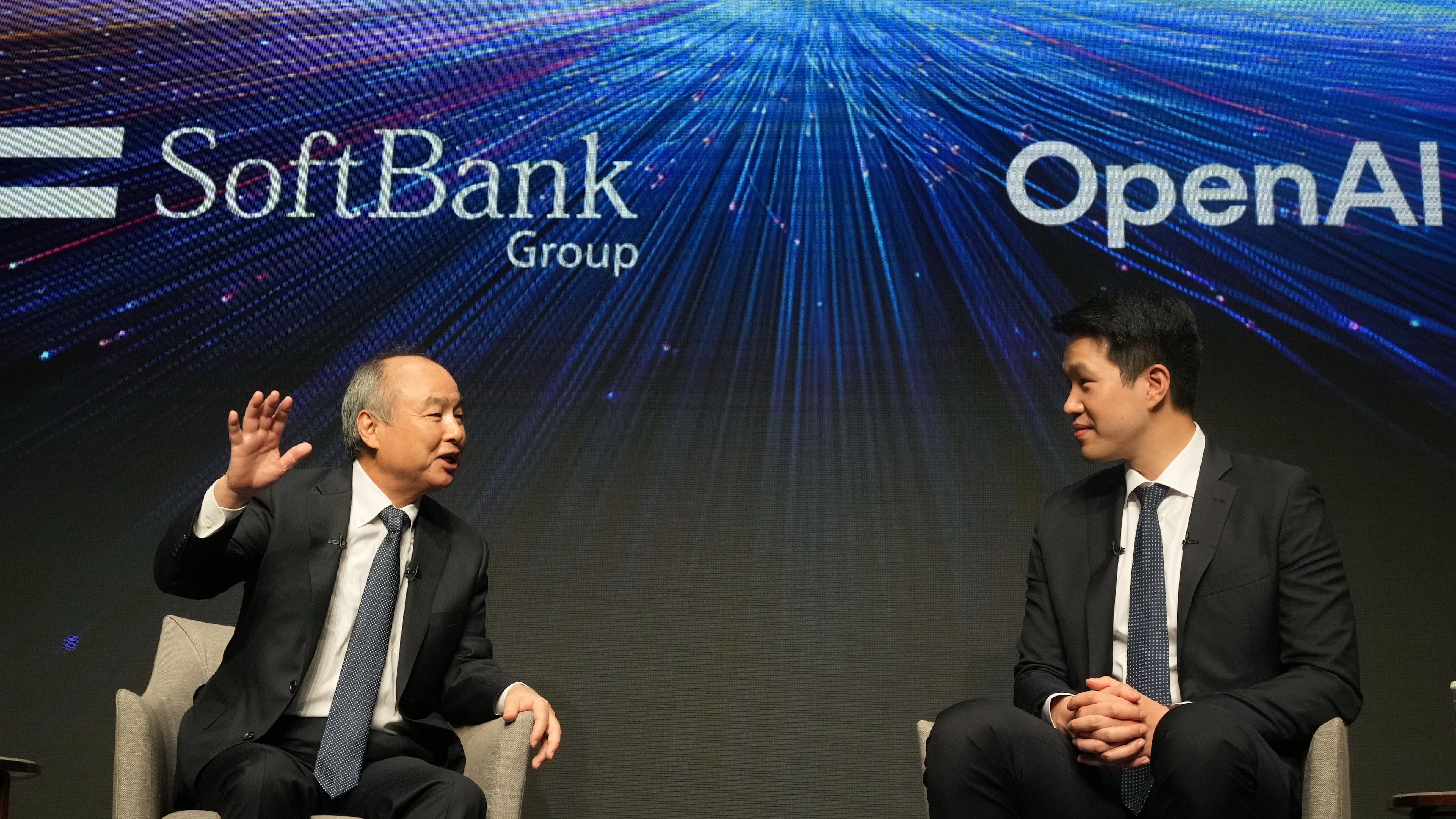 Masayoshi Son, left, chairman and CEO of SoftBank Group, speaks as Mark Chen, chief research officer for OpenAI, listens during a talk at their business event at a hotel in Tokyo, Tuesday, June 16, 2026. (AP Photo/Hiro Komae)