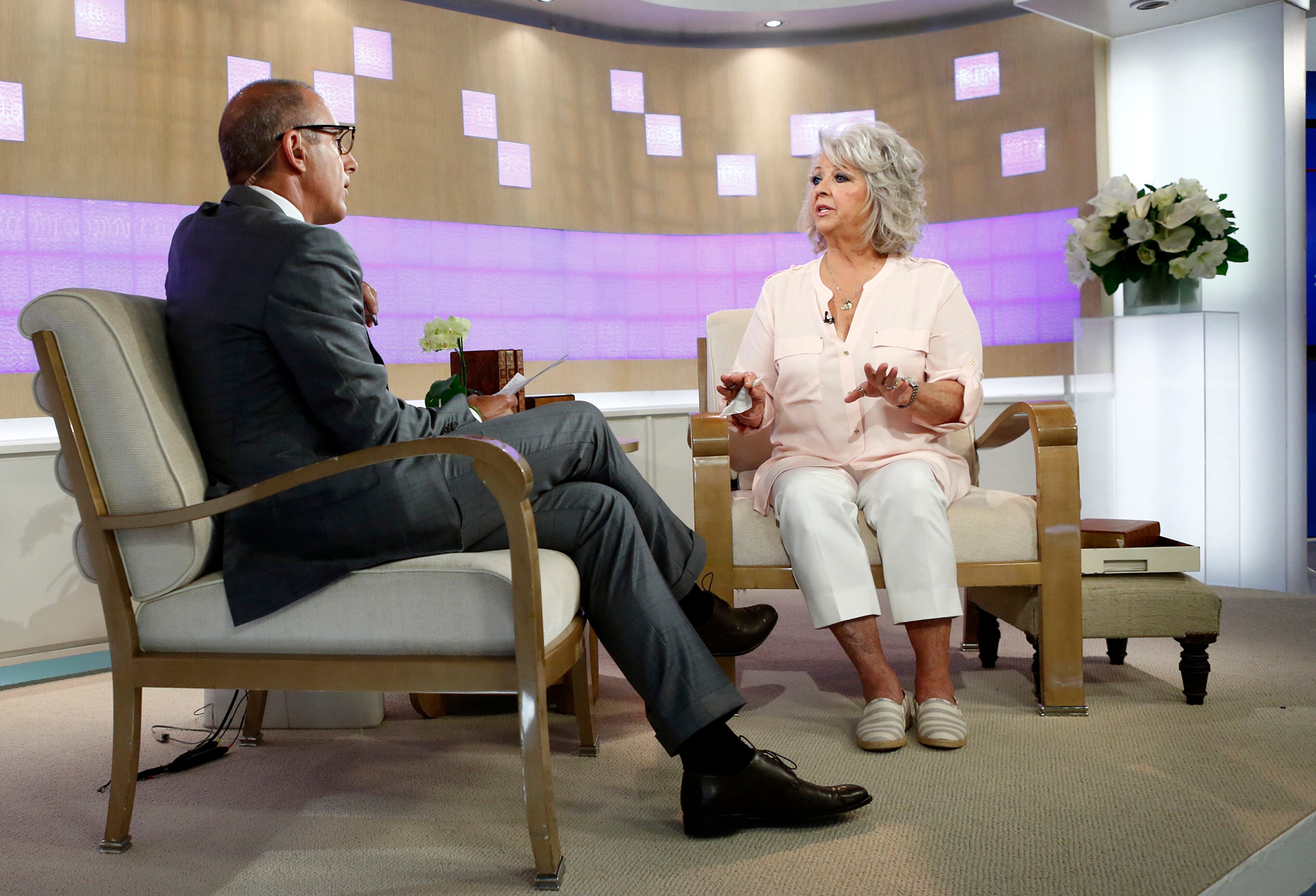 In this publicity image released by NBC, celebrity chef Paula Deen appears on NBC News' "Today" show, with host Matt Lauer, Wednesday, June 26, 2013 in New York. Deen dissolved into tears during a "Today" show interview Wednesday about her admission that she used a racial slur in the past. The celebrity chef, who had backed out of a "Today" interview last Friday, said she was not a racist and was heartbroken by the controversy that began with her own deposition in a lawsuit. Deen has been dropped by the Food Network and as a celebrity endorser by Smithfield Foods. (AP Photo/NBC, Peter Kramer)