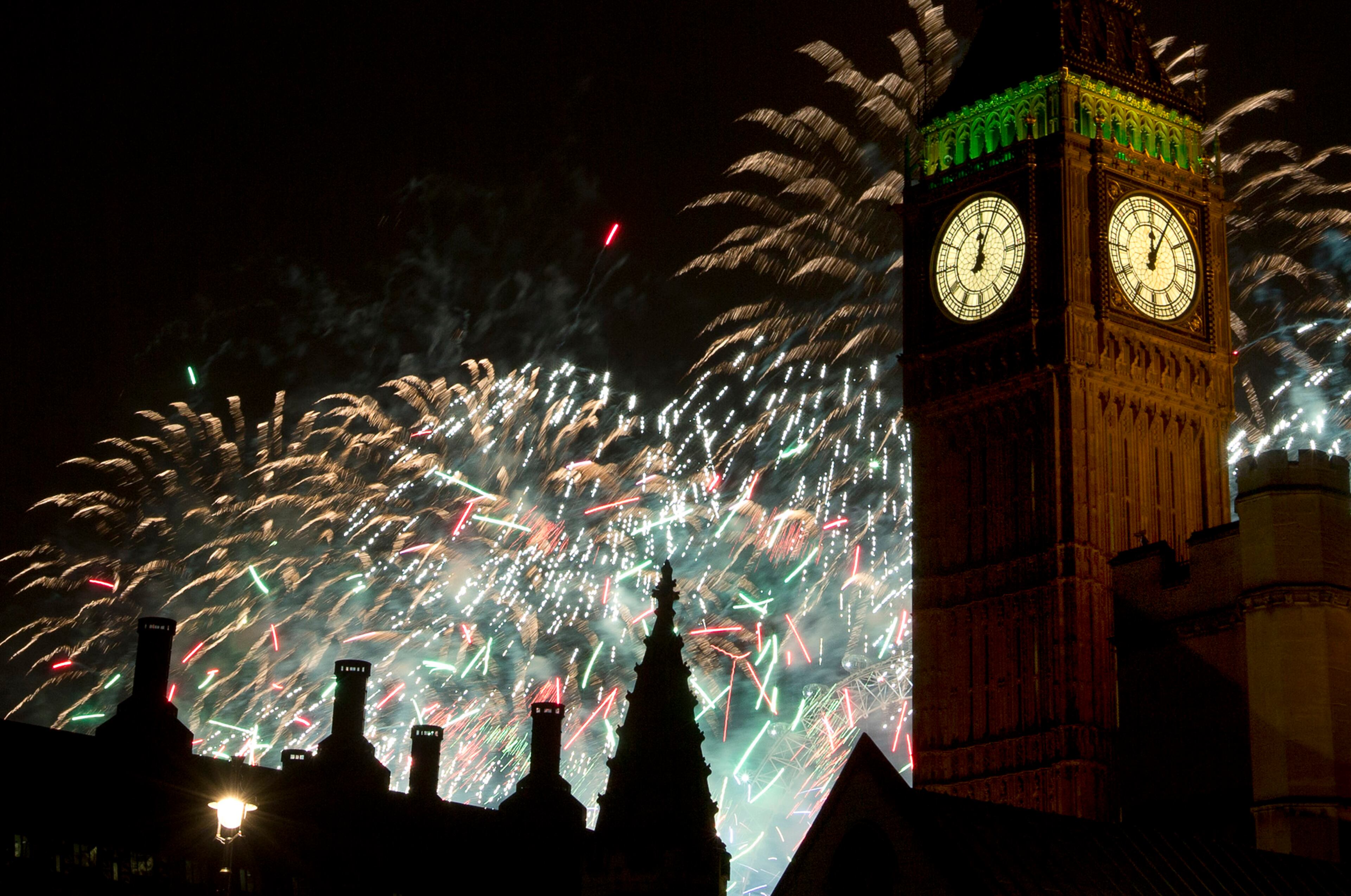 Fireworks explode over the Houses of Parliament, including Queen Elizabeth II tower which holds the bell known as Big Ben as London celebrates the arrival of New Year's Day Wednesday, Jan. 1, 2014. The annual firework display is the culmination of the New Year's Eve celebrations.(AP Photo/Alastair Grant)