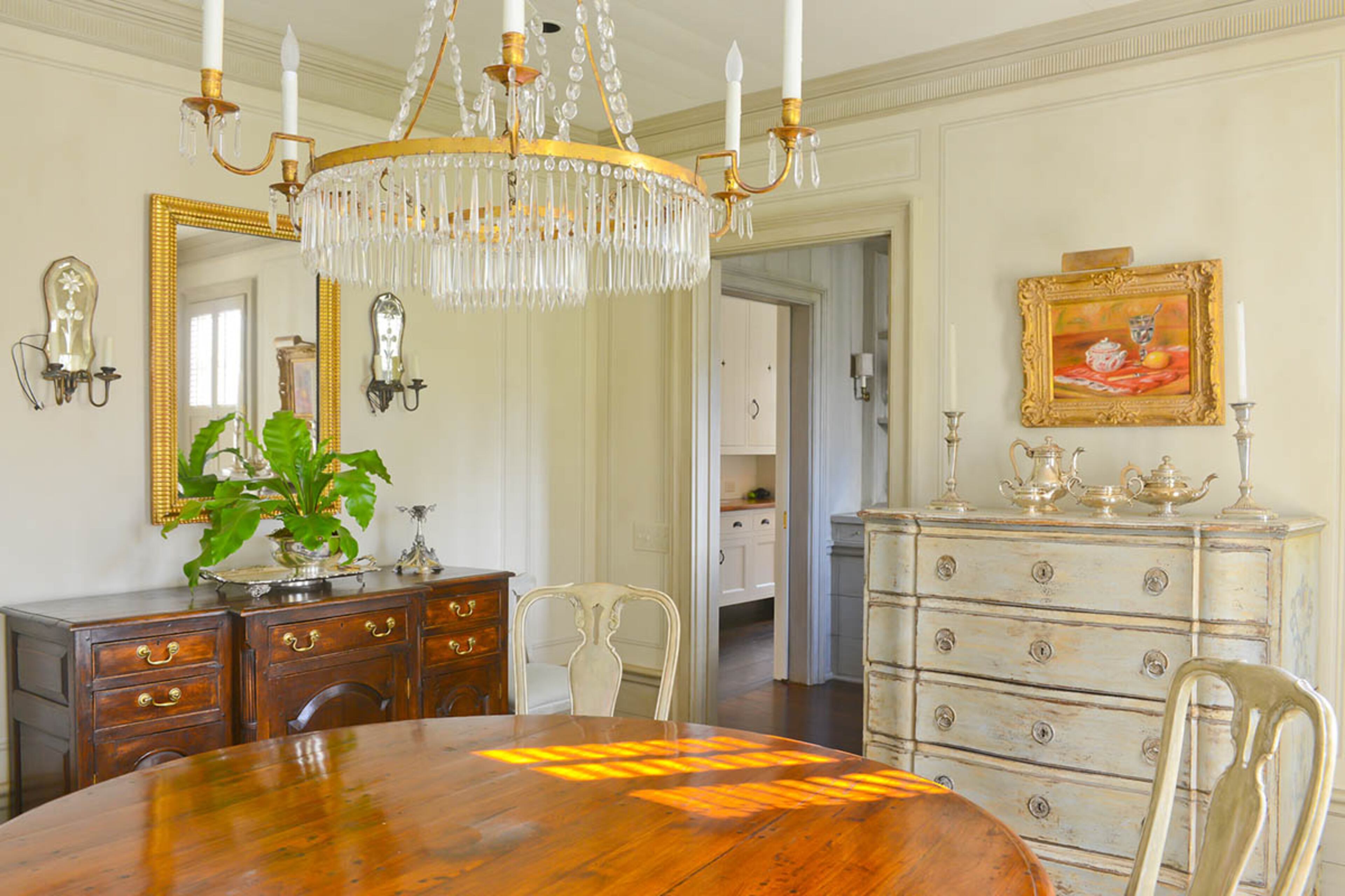 Evie Johnson brought the dramatic chandelier that hangs in her Buckhead dining room with her when she moved from San Francisco. The antique dining table, selected by interior designer Jacquelynne P. Lanham, pairs with chairs from A. Tyner Antiques. A silver tea set, which once belonged to Johnson's mother, polishes off the light-filled room's traditional decor.