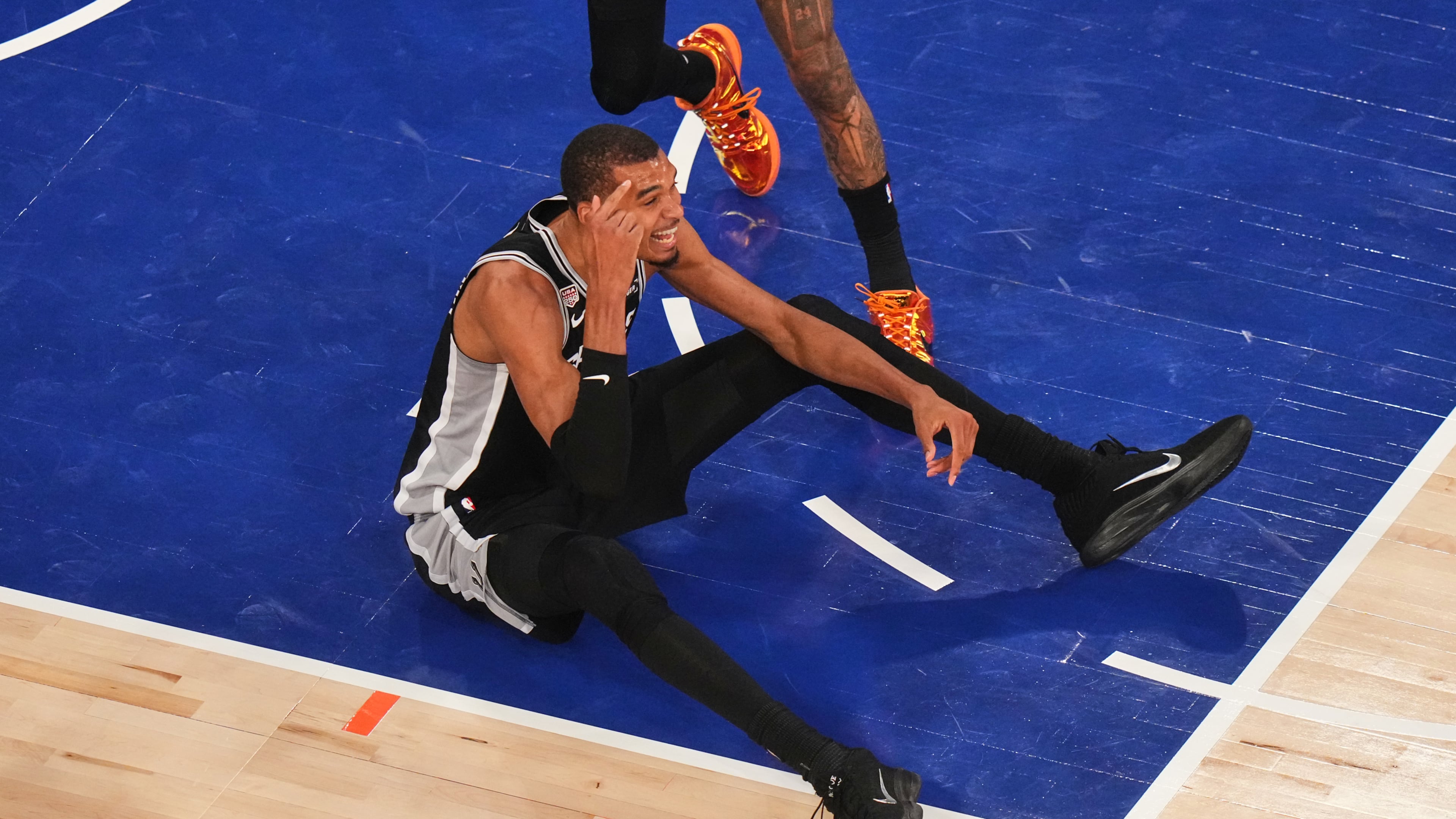 San Antonio Spurs forward Victor Wembanyama sits on the court after being knocked down during the first half of Game 4 of the NBA Finals basketball series against the New York Knicks, Wednesday, June 10, 2026, in New York. (AP Photo/Frank Franklin II)