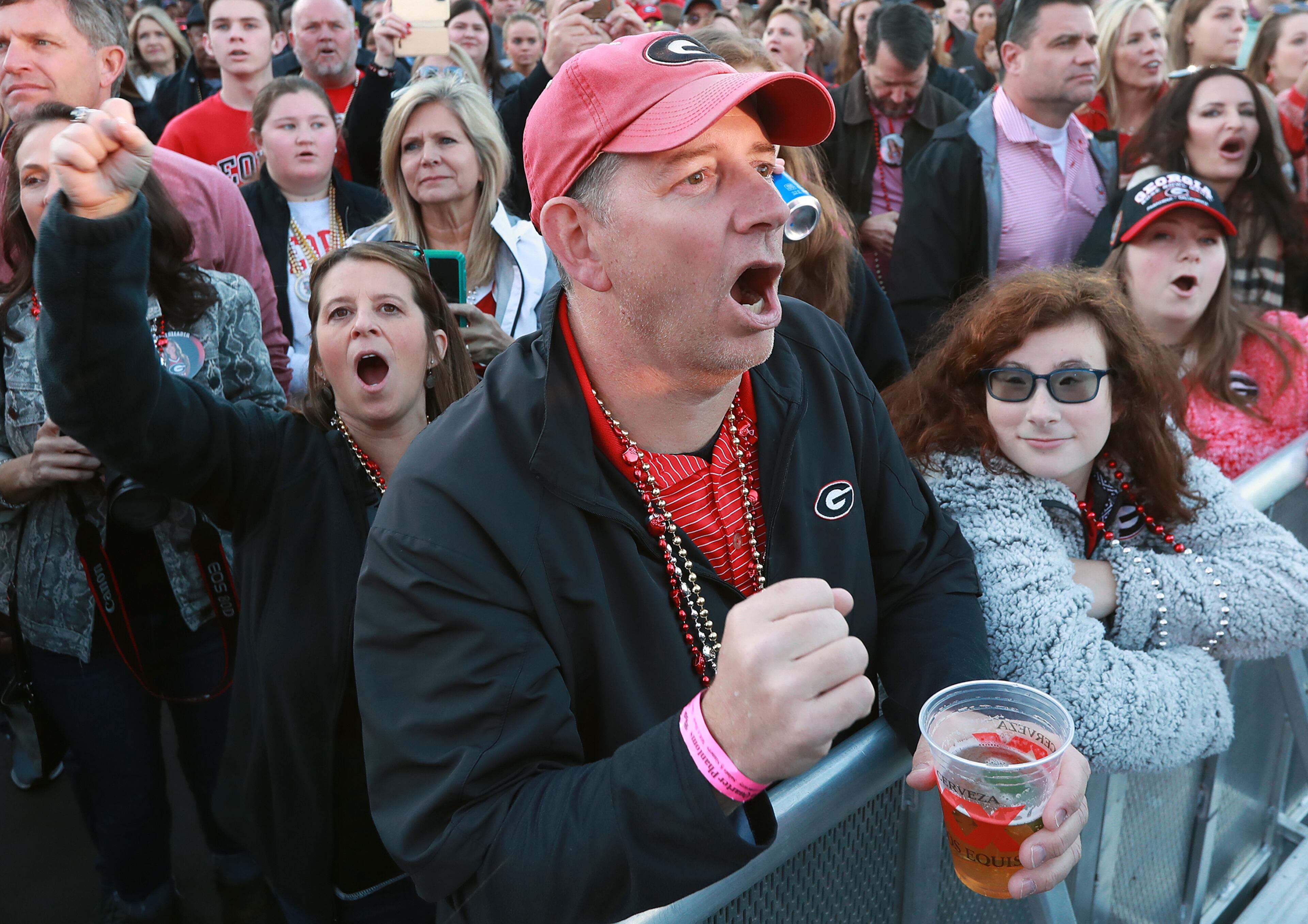Stacy and Mike Loverde (from the left) and their daughters Addison and Samantha cheer for the Bulldogs. Curtis Compton ccompton@ajc.com