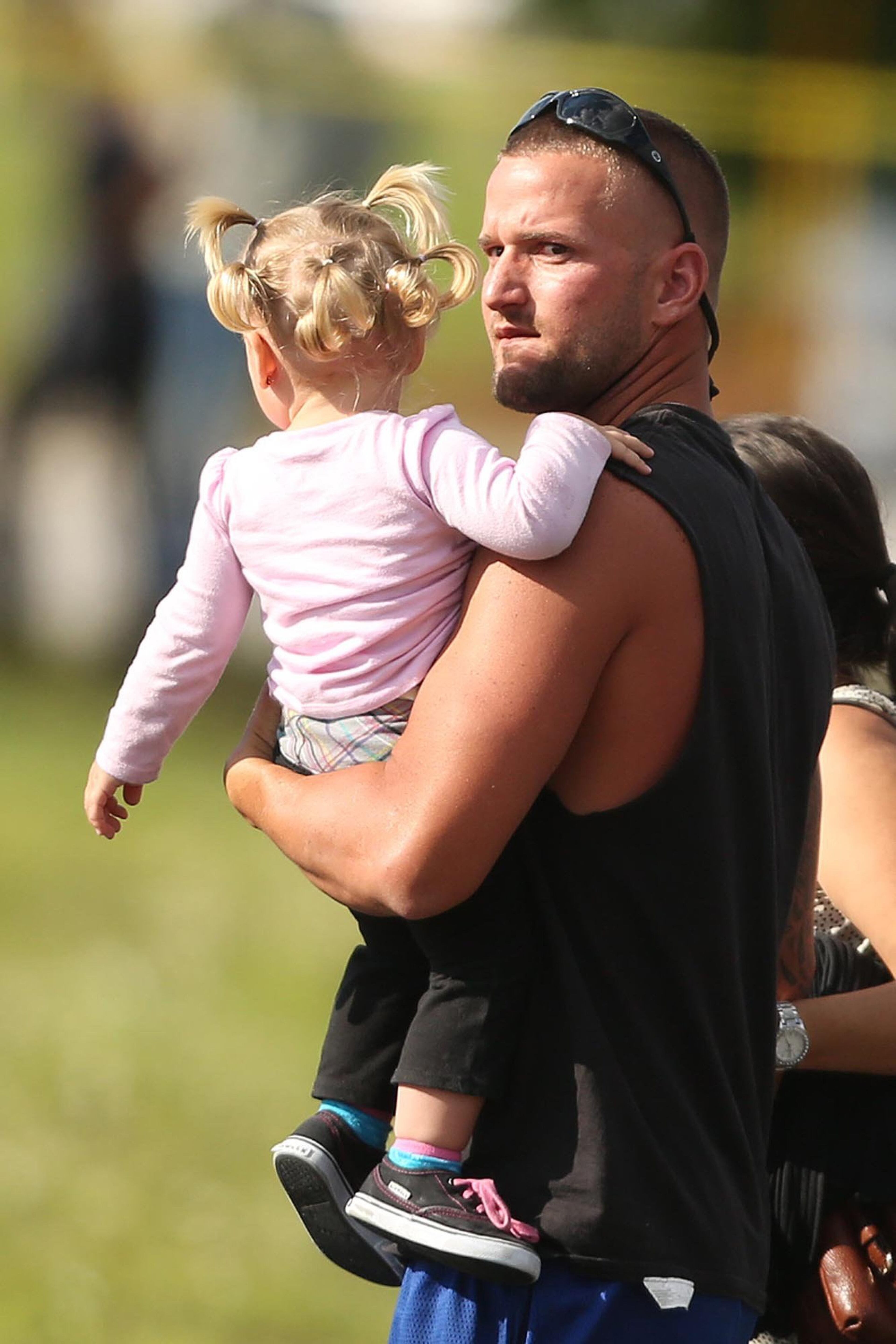 Children are escorted by their parents from the KinderCare Learning Center in Winter Park, Fla., after several children were injured, one fatally, when a car crashed into the facility Wednesday, April 9, 2014. (Stephen M. Dowell, Orlando Sentinel/MCT)