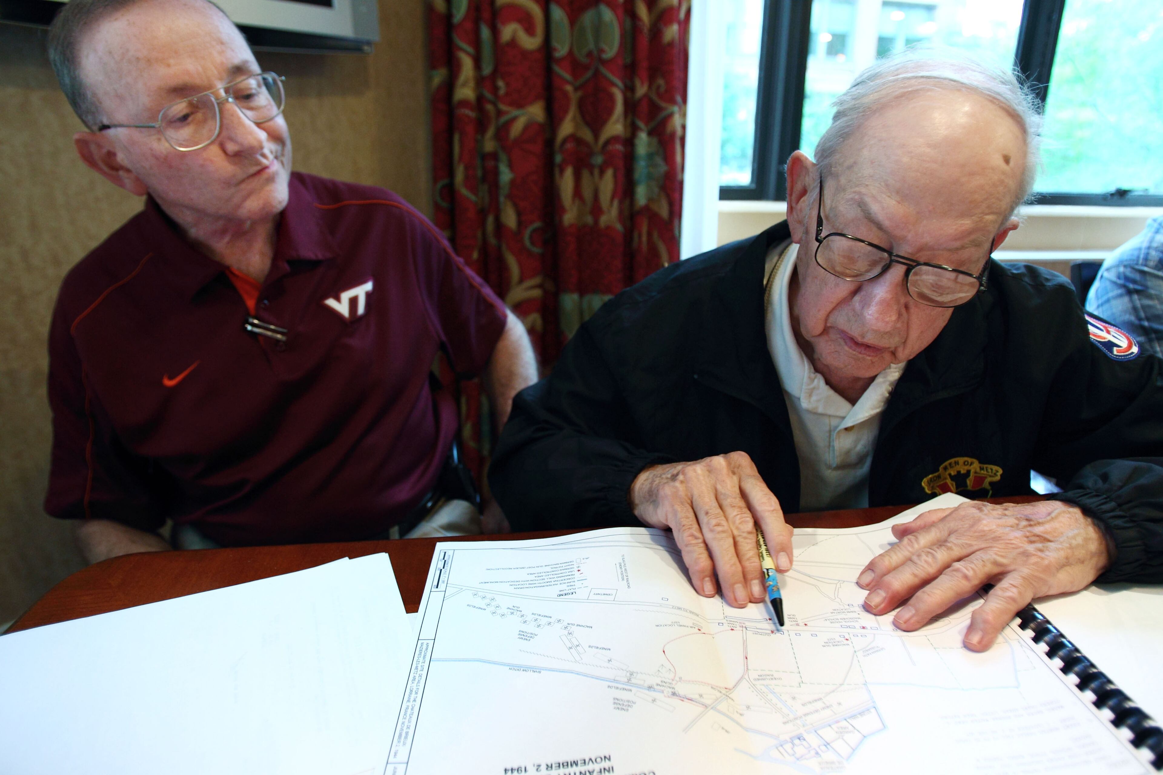 Retired Maj. Gen. James E. Archer (left) looks on as retired Pvt. Steve Bodnar points to the position where he was injured during World War II in France during a reunion of members of the 95th Infantry Division in Memphis, Tenn.