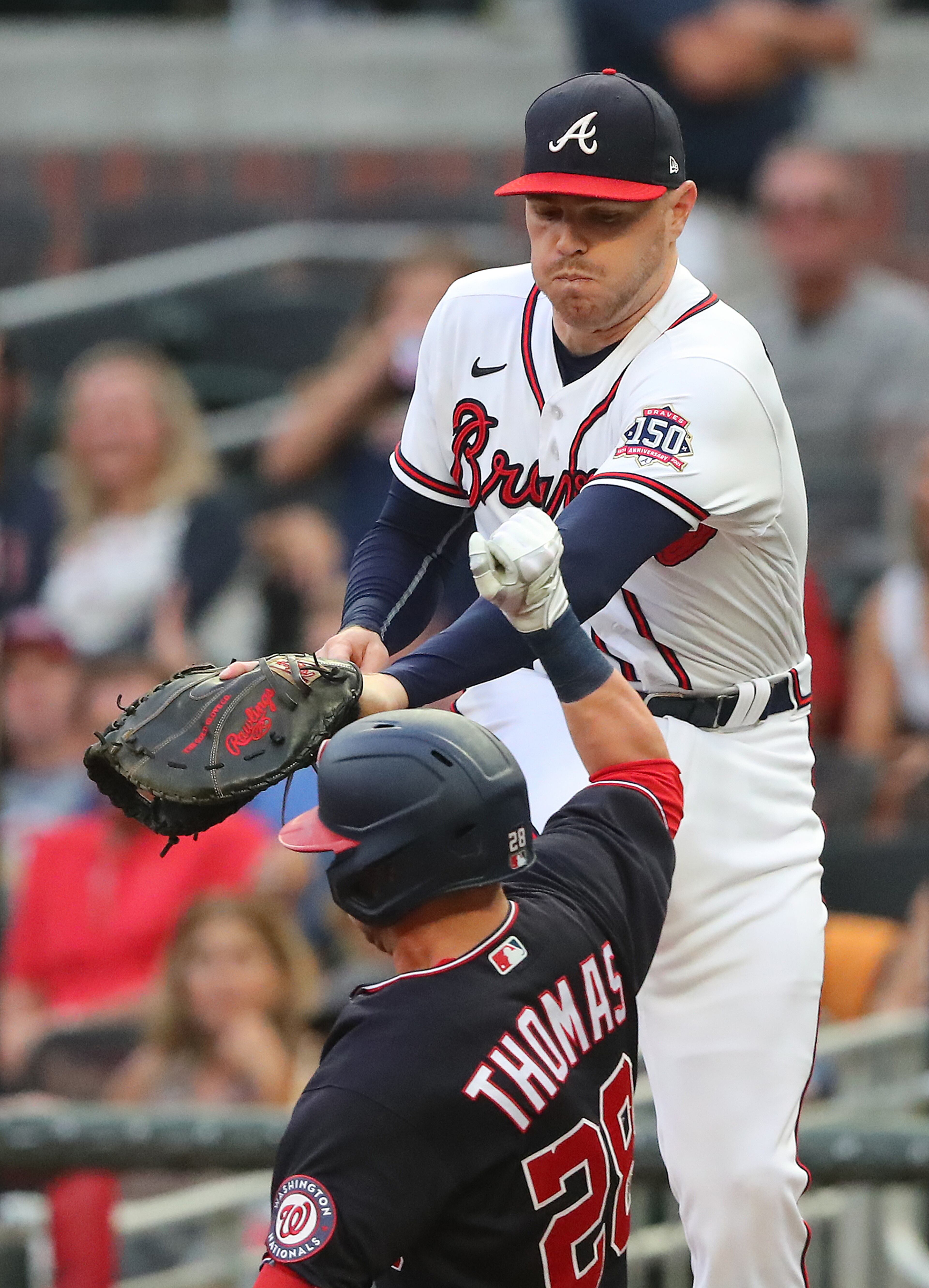 Atlanta Braves first baseman Freddie Freeman takes a wild throw from third baseman Austin Riley but can't get the tag in time on Washington Nationals' Lane Thomas. “Curtis Compton / Curtis.Compton@ajc.com”