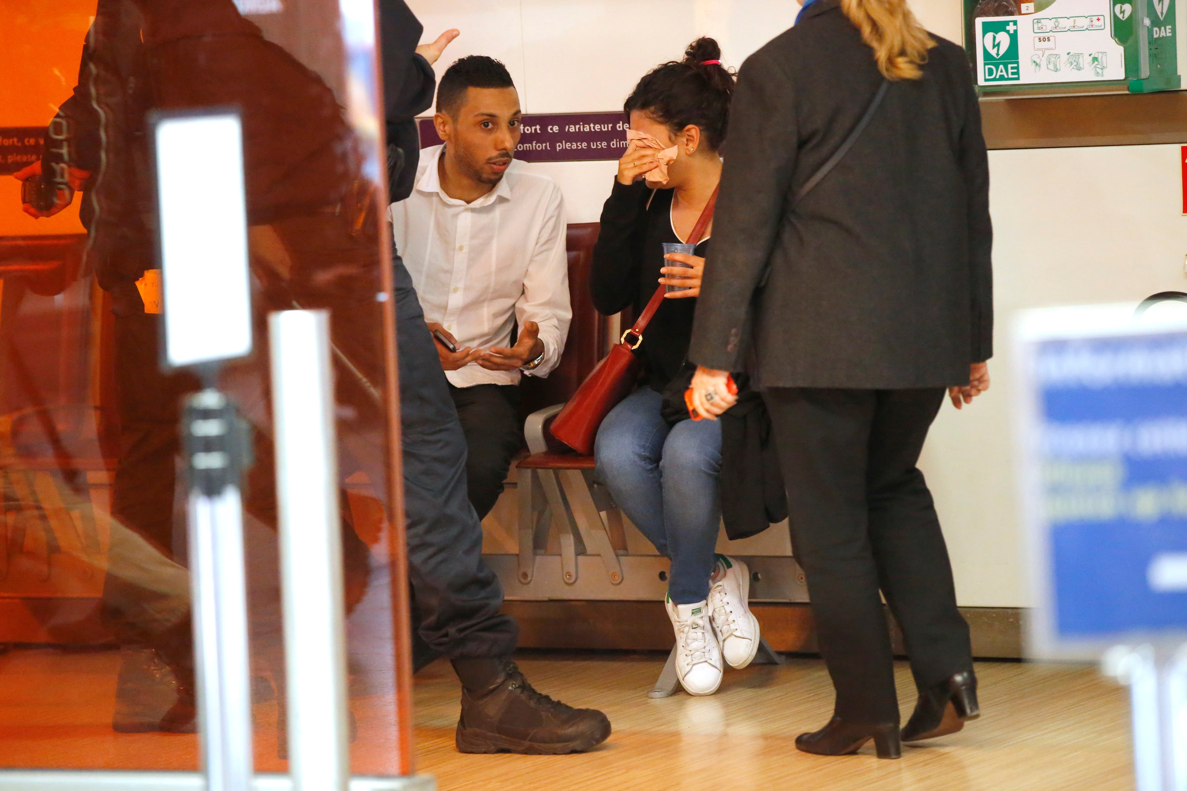 A relative of the victims of the EgyptAir flight 804 wipes her tears as she is comforted by unidentified people at Charles de Gaulle Airport outside of Paris, Thursday, May 19, 2016. Egyptian aviation officials say an EgyptAir flight from Paris to Cairo with 66 passengers and crew on board has crashed. (AP Photo/Michel Euler)