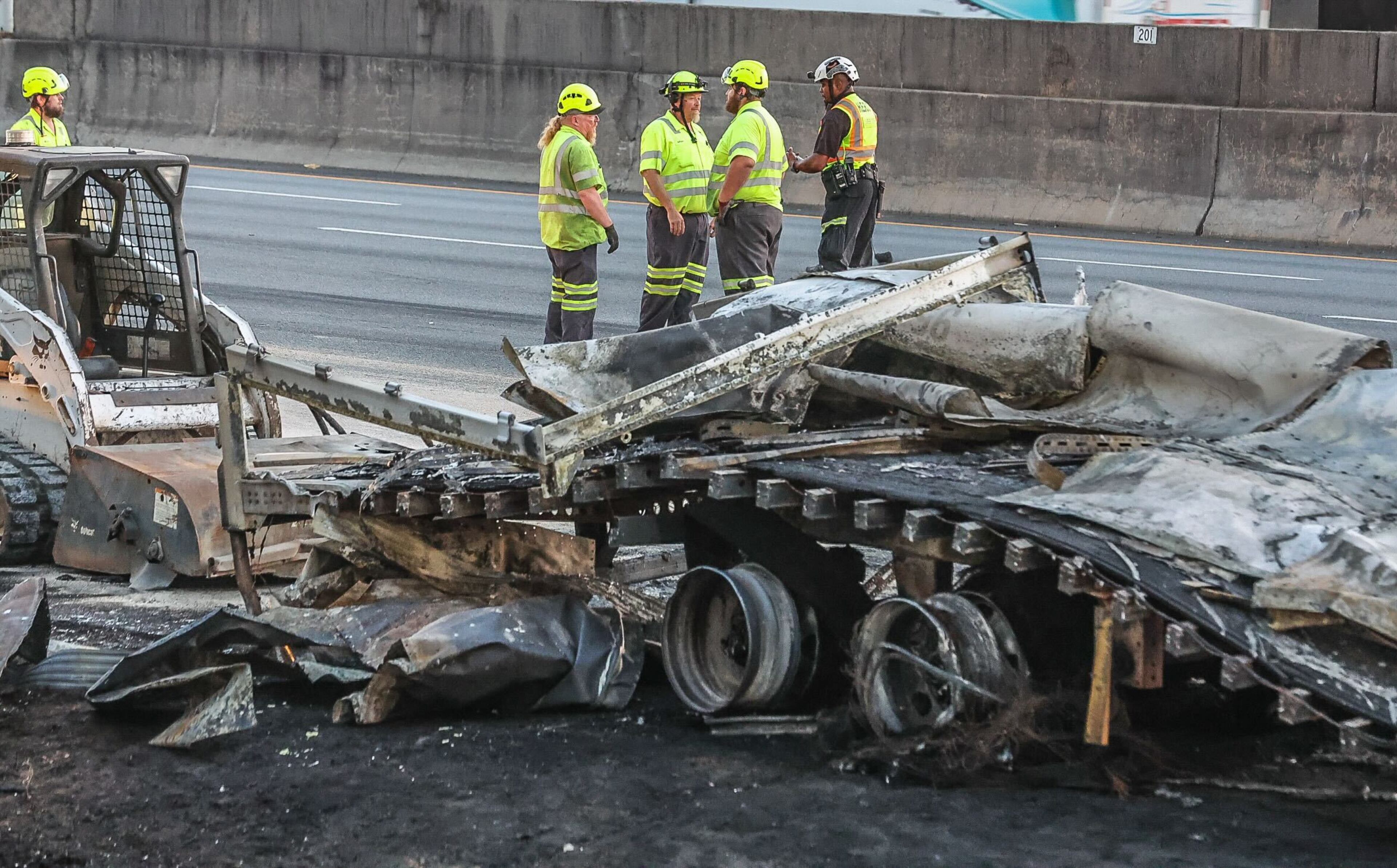 Traffic was shut down for hours on I-75 South in Cobb County after a tractor-trailer carrying barrels of brake fluid crashed and caught on fire.