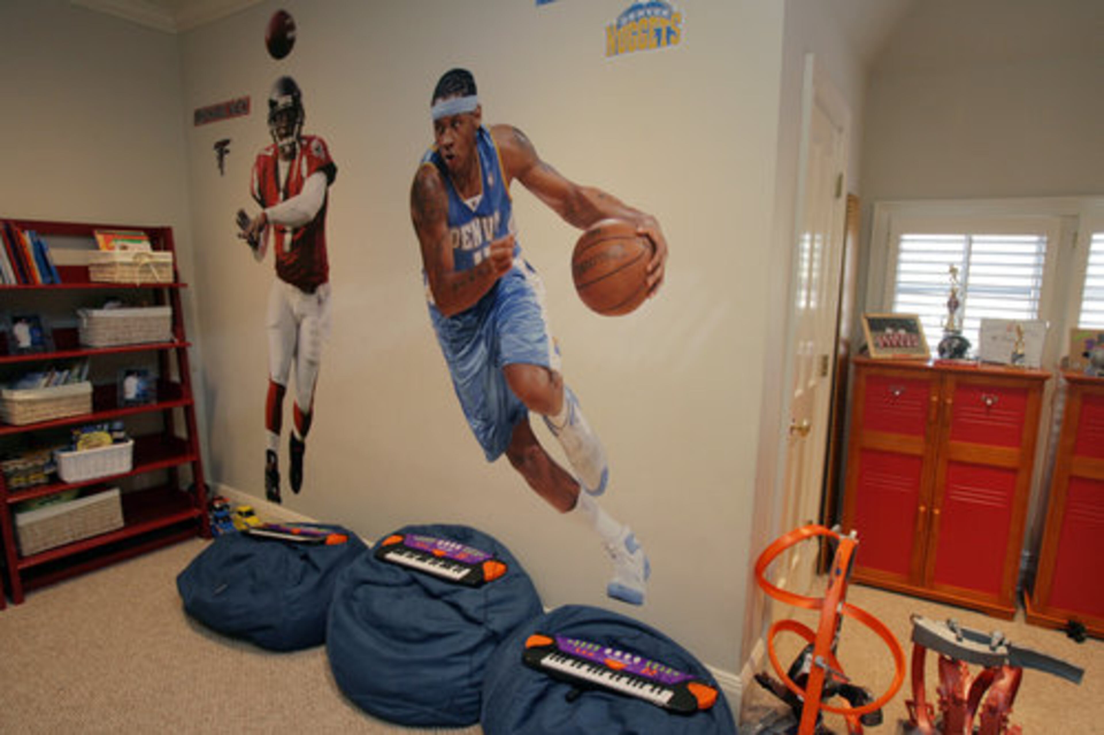 Life-sized depictions of a kid's passions, such as sports, can have an inspirational effect. This room, created by radio host Frank Ski for his son, also includes moveable beanbag chairs for playtime as well as storage for lots of toys and activity supplies.