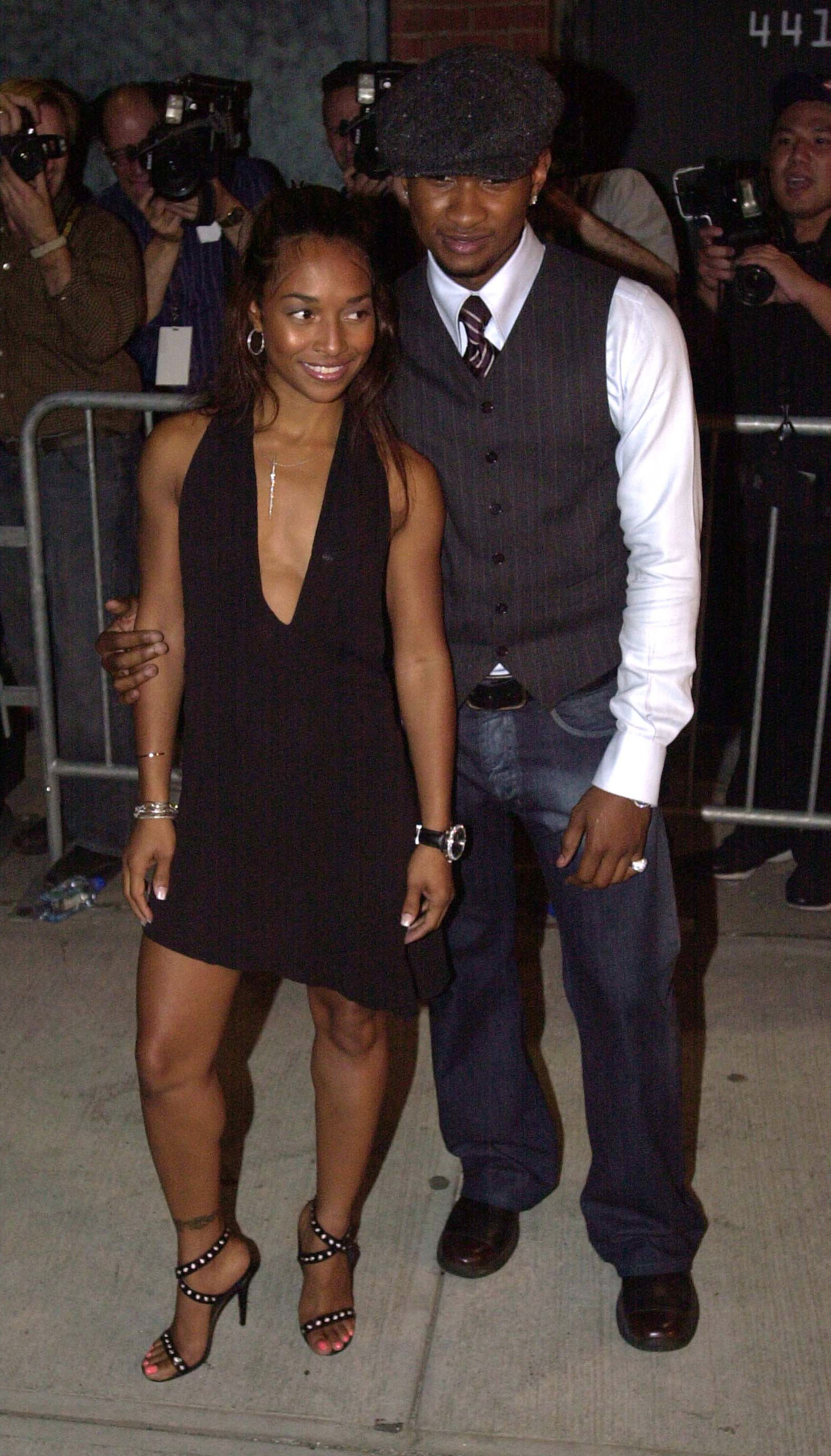 NEW YORK - SEPTEMBER 20: Singer Usher (R) and Rozanda "Chilli" Thomas of the group TLC attend the opening of designer Stella McCartney's New York store during the Mercedes-Benz Fashion Week September 20, 2002 in New York City. (Photo by Keith Bedford/Getty Images)