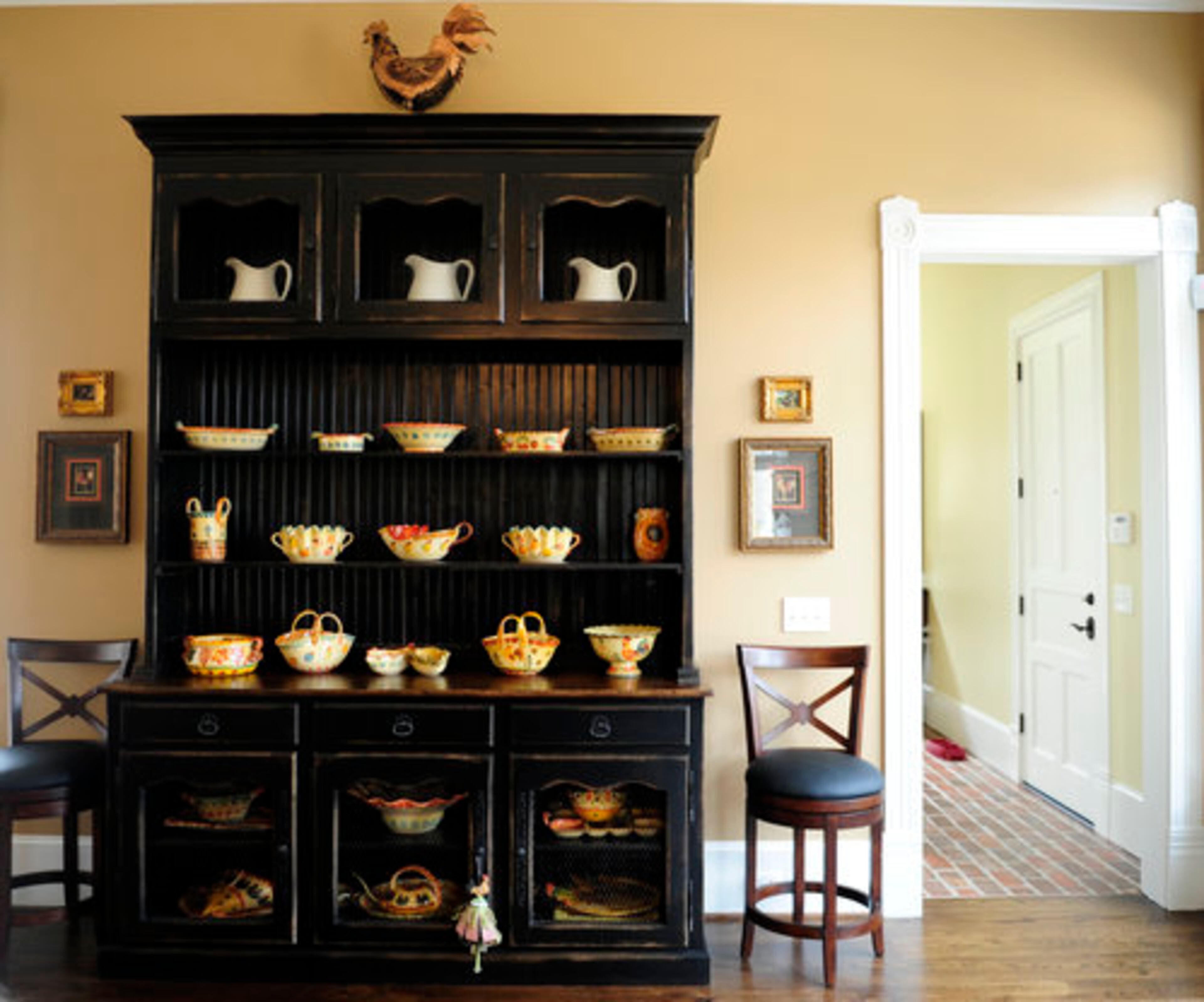 The look of the kitchen carried over from the Mableton home. At one time, Roy wanted to live on the Western edge of Cobb County. Marie didn't want to live that far out, so she joked she'd have a country kitchen. She liked the rooster look and began a collection that transferred to this home. In this kitchen, she added a rooster painting she found in New Orleans. It hangs over the stove.