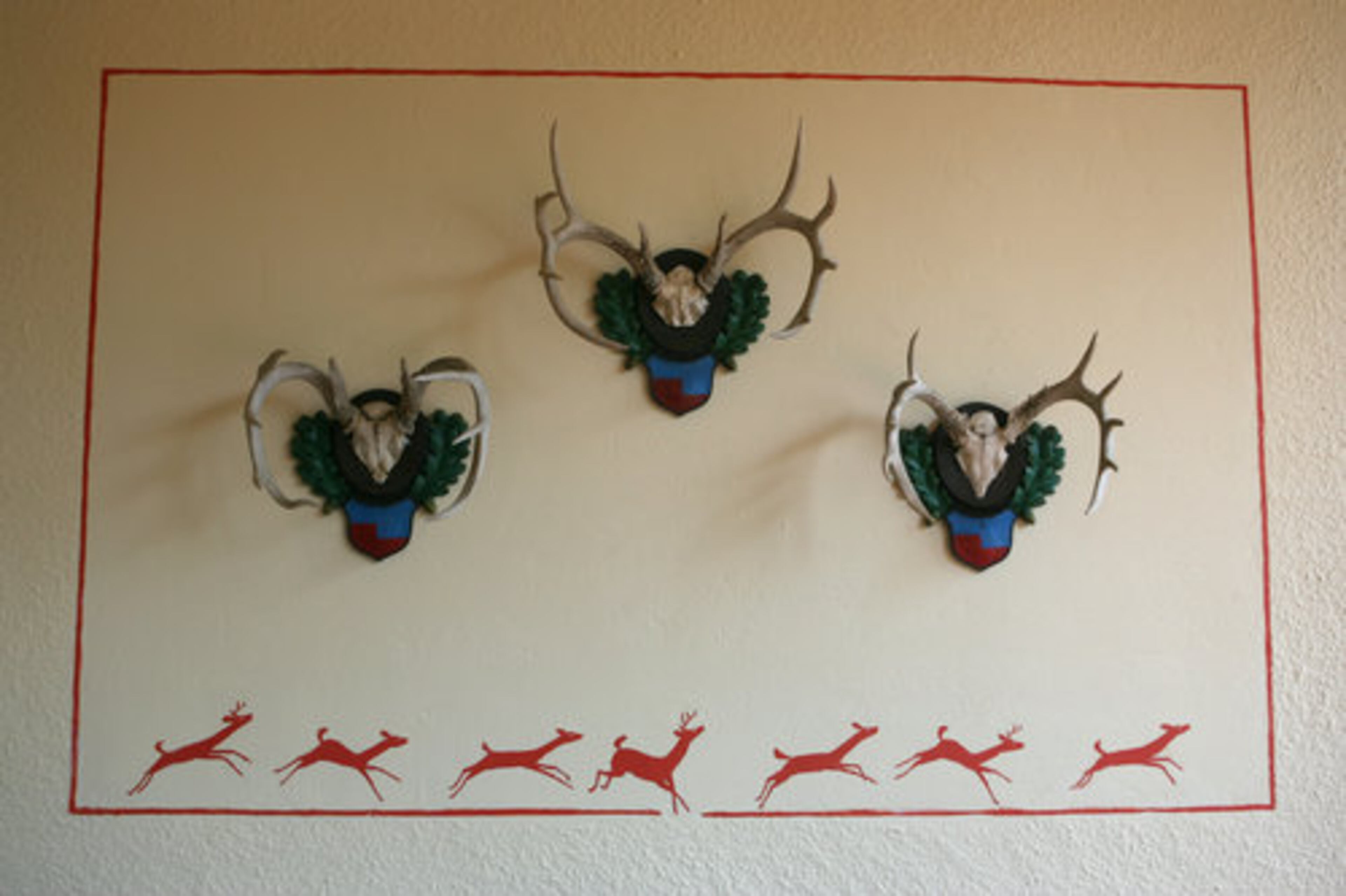 Hunting trophies are incorporated into the exterior decorations of the Kauka estate, a style common in the architecture of Bavaria. These colorful depictions adorn the porch at Chinquapin's primary residence.