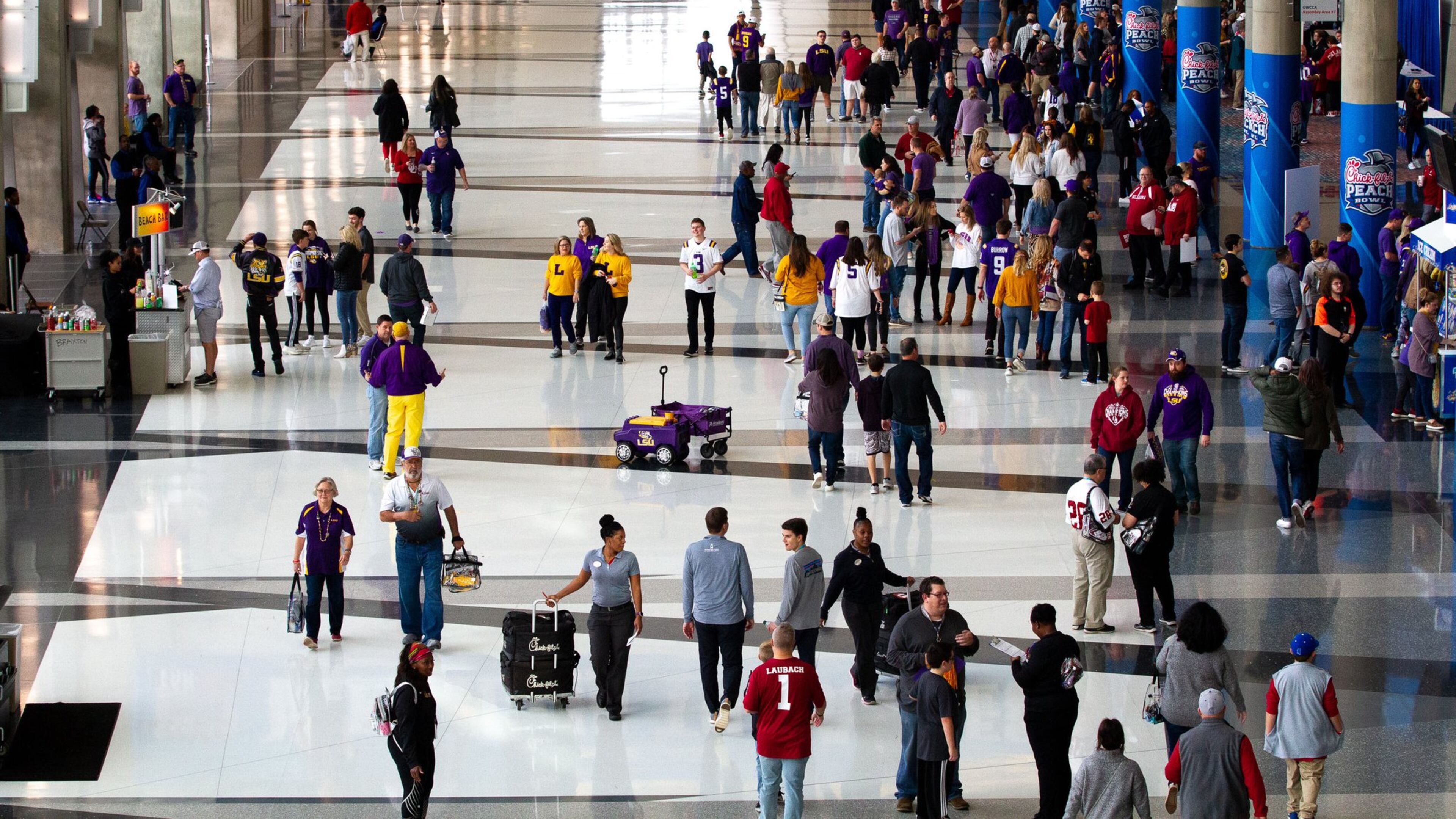 High-profile sports events are a foundation of Atlanta’s hospitality sector. Here, fans enter the Georgia World Congress Center for the Chick-fil-A Peach Bowl FanFest in 2019. STEVE SCHAEFER / SPECIAL TO THE AJC
