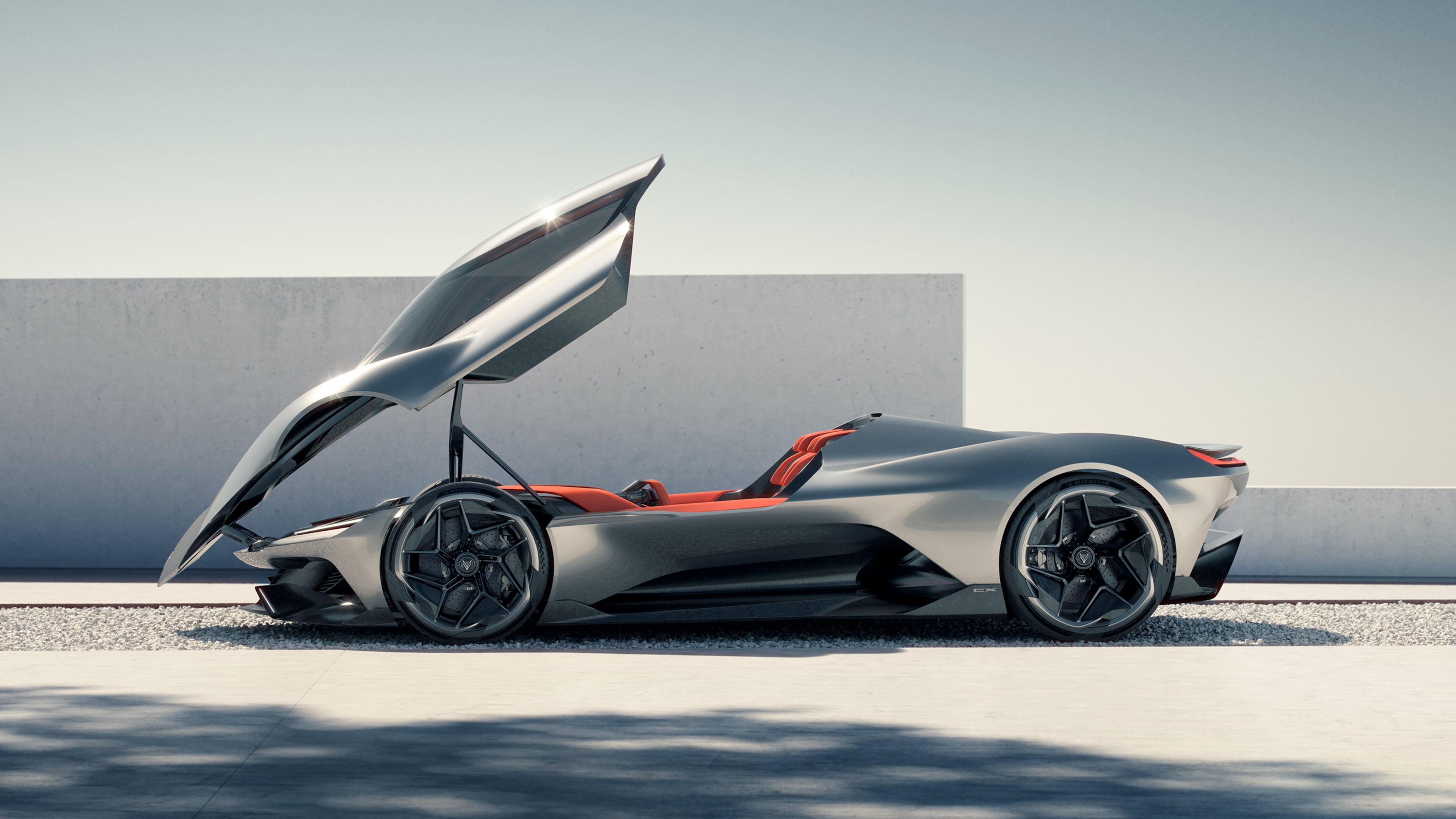 The Chevrolet CX features a long, low stance, slanting nose, quad taillights and a modernized dual-flag logo. It's also fully electric, with four motors, one at each wheel. (Courtesy of Chevrolet)