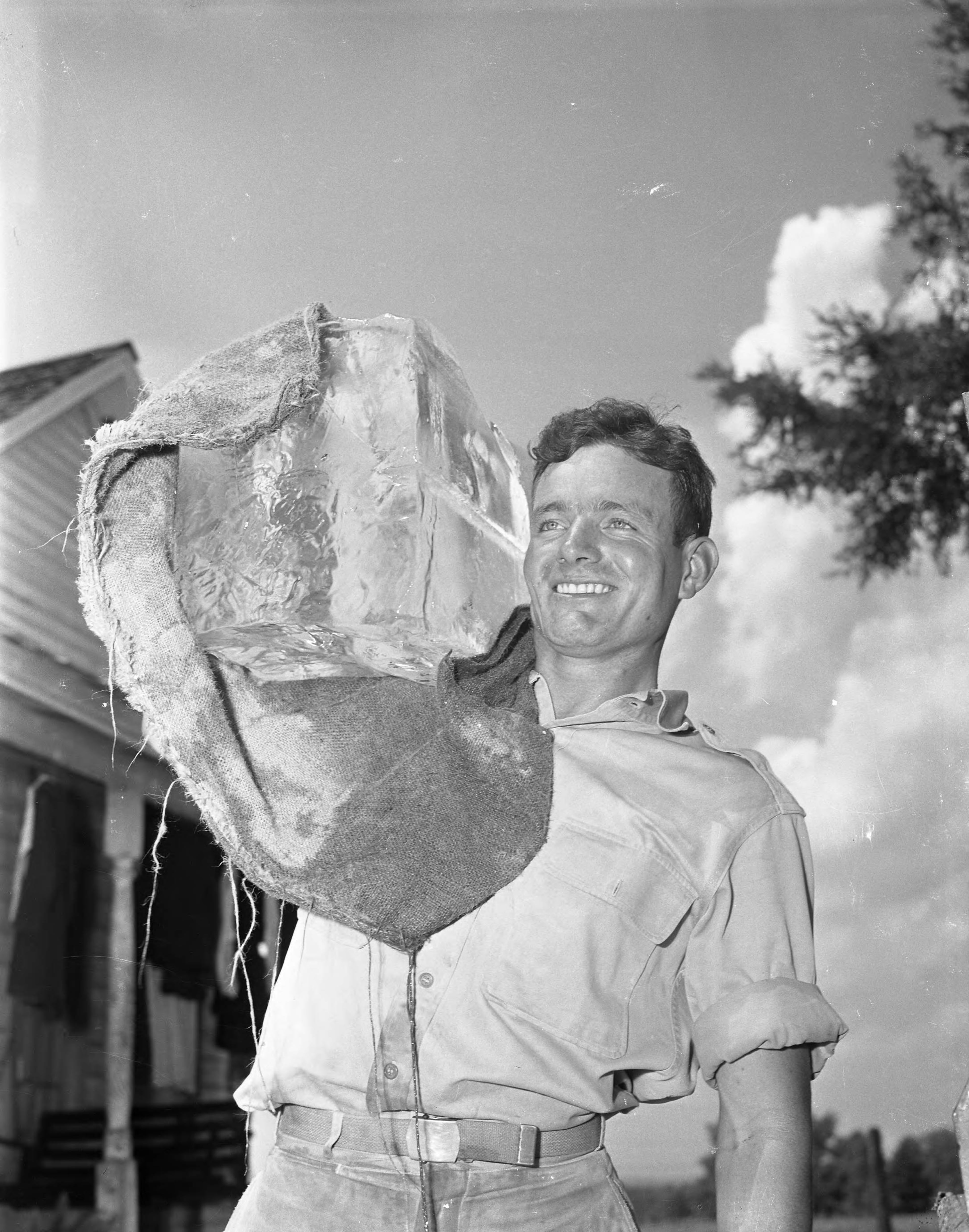 Georgians kept their cool in August 1945 with a little help from the local iceman. Thomas Weller delivers a block of ice by carrying it on his shoulder.