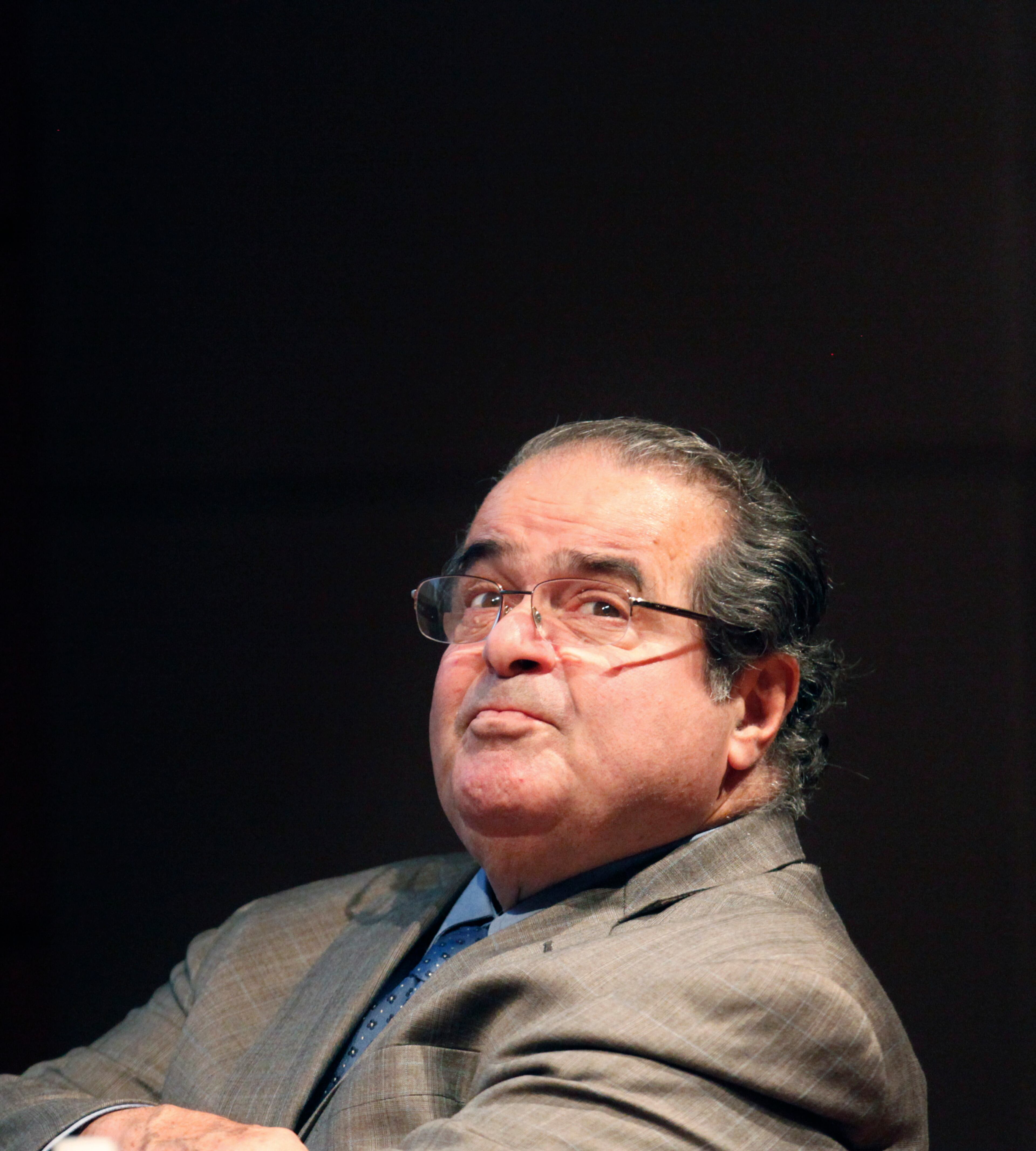 In this Oct. 18, 2011 file photo, U.S. Supreme Court justice Antonin Scalia looks into the balcony before addressing the Chicago-Kent College Law justice in Chicago. On Saturday, Feb. 13, 2016, the U.S. Marshals Service confirmed that Scalia has died at the age of 79. (AP Photo/Charles Rex Arbogast, File)