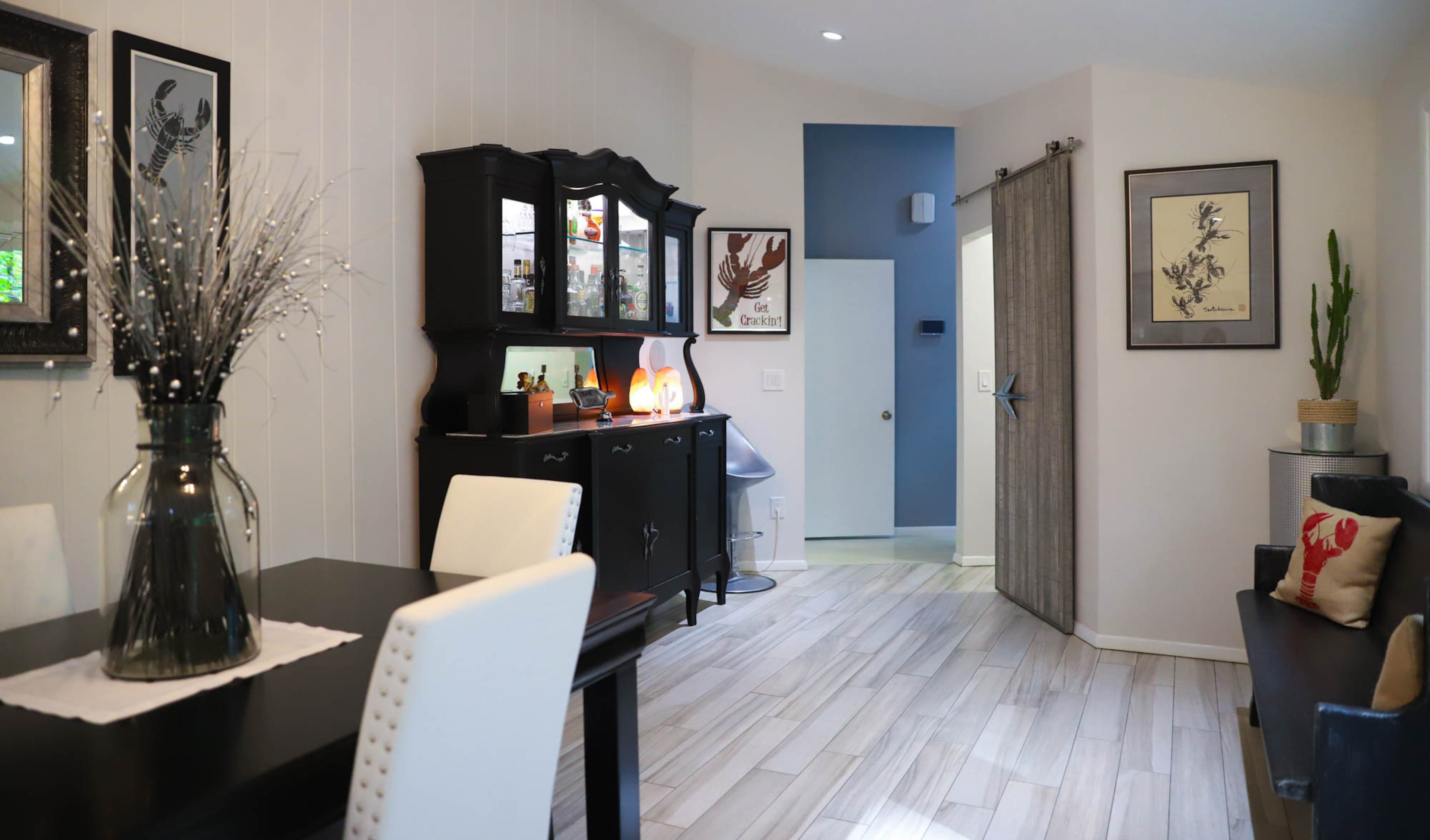 In the dining room and kitchen, a hue of Silver Dust (a Behr Premium Plus Ultra paint) is accented by dark furniture like the hutch, an antique auction find from Roswell that's been repurposed as a dry bar. Text and photos by Fast Copy News Service's Kat Khoury and Reynolds Rogers.