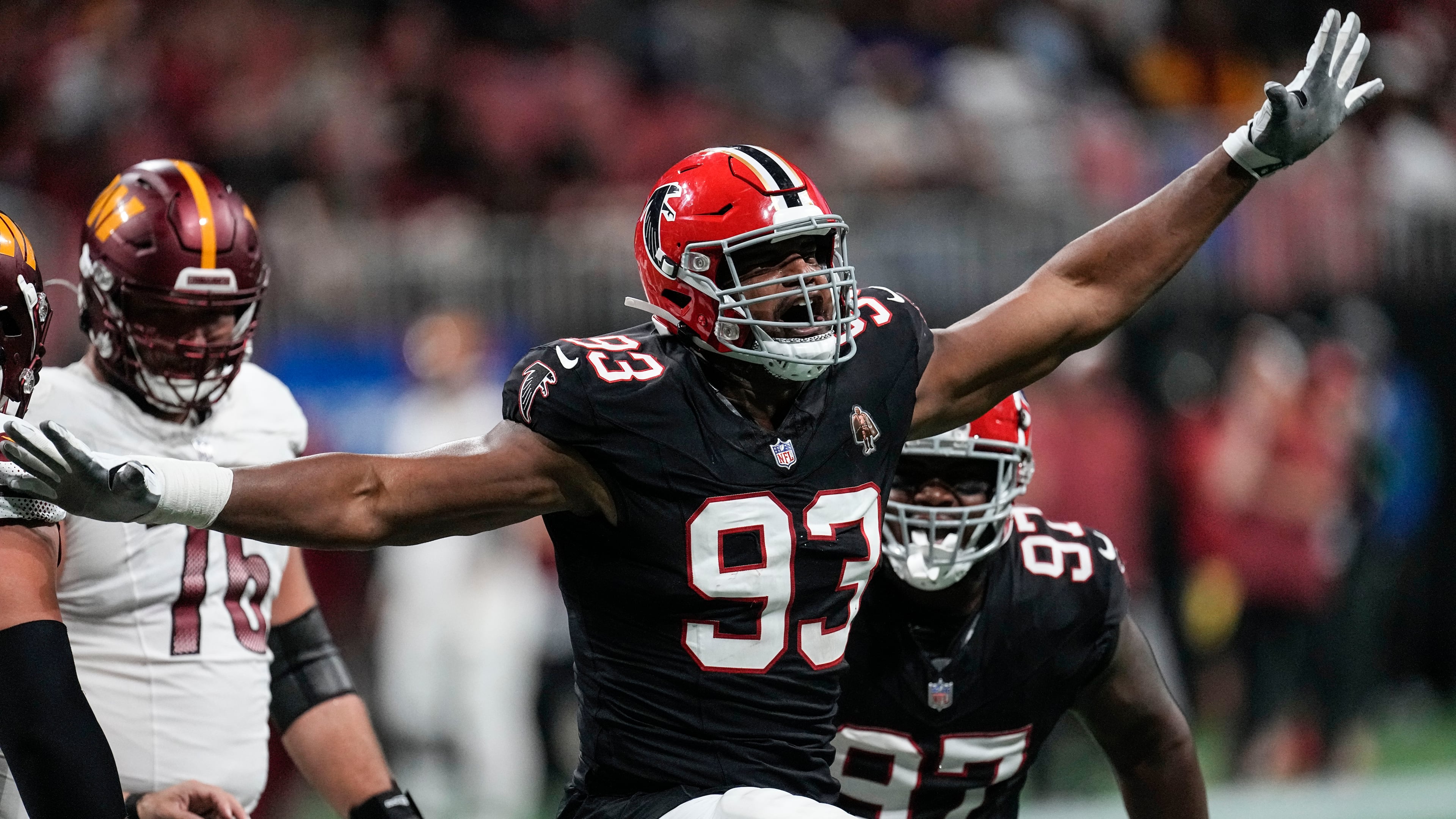 Atlanta Falcons defensive tackle Calais Campbell (93) celebrates his 100th career quarterback sack against the Washington Commanders during the first half of an NFL football game, Sunday, Oct. 15, 2023, in Atlanta. (AP Photo/John Bazemore)