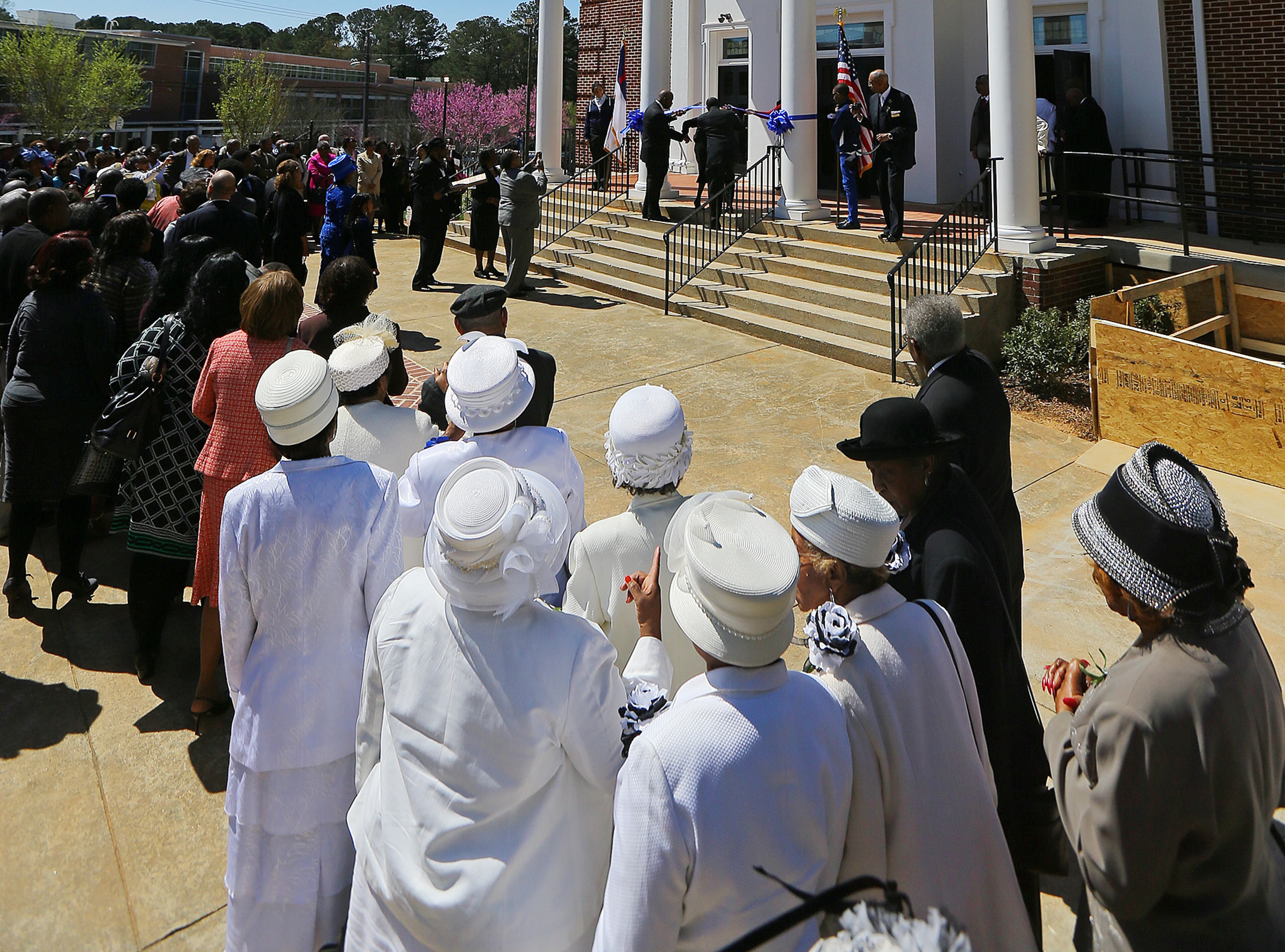 Women of the church, some dressed in white, look on for the Ribbon Cutting Ceremony during the Entrance Service at Mount Vernon Baptist Church on Palm Sunday, March 29, 2015, in Atlanta. The church moved locations to make way for the Falcons new stadium. Curtis Compton / ccompton@ajc.com