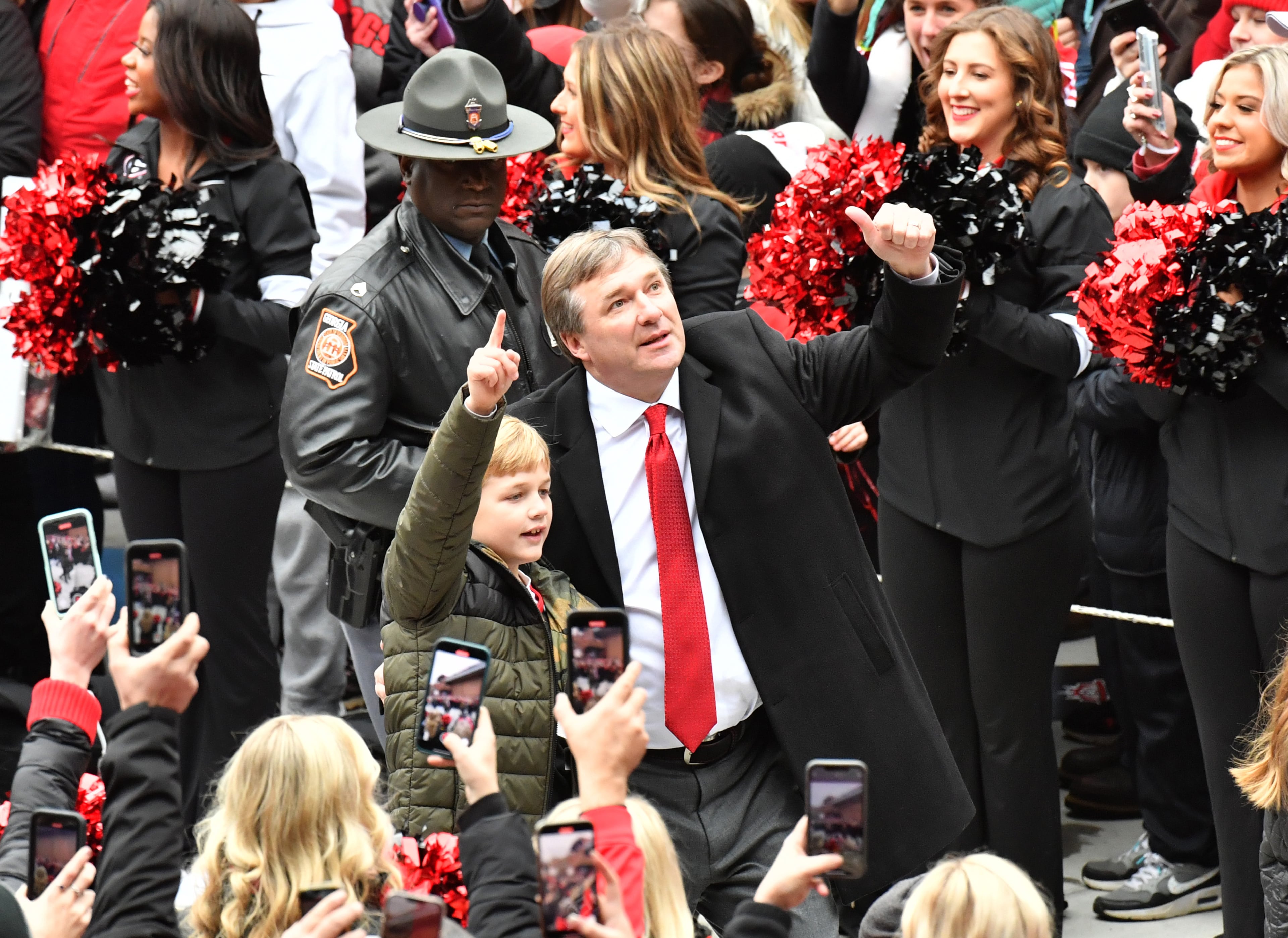 January 15, 2022 Athens - Georgia's head coach Kirby Smart hugs his son Andrew take in the DawgWalk during the celebration of Georgia’s College Football Playoff national championship at Sanford Stadium in Athens on Saturday, January 15, 2022. Georgia captured the national championship, its first since the 1980 season, with a 33-18 victory over Alabama at Lucas Oil Stadium in Indianapolis. (Hyosub Shin / Hyosub.Shin@ajc.com)