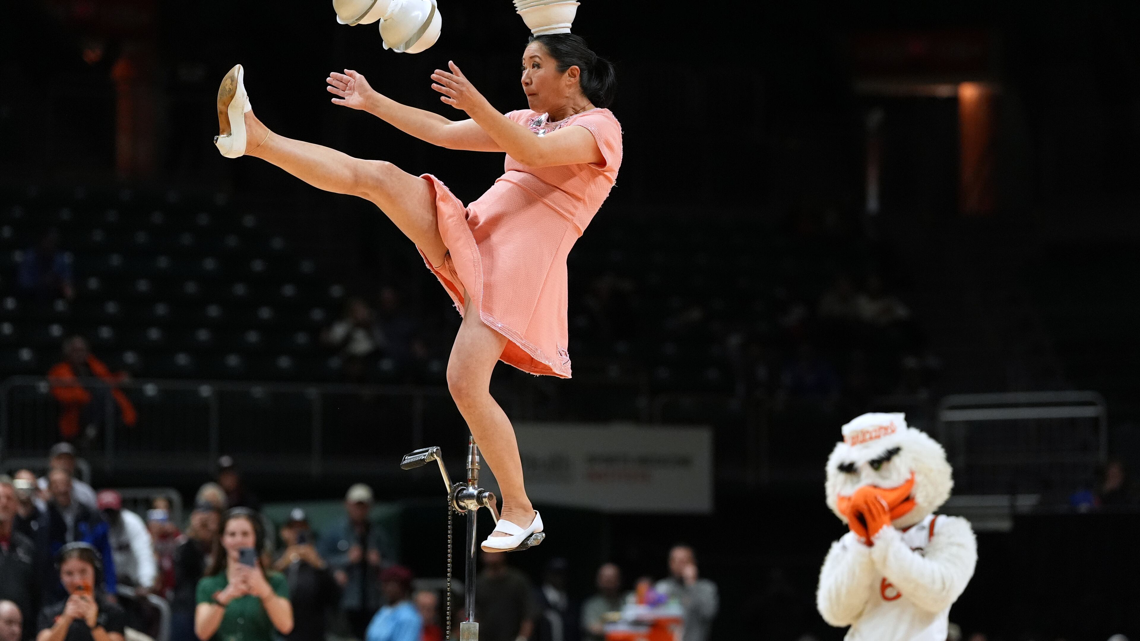 Red Panda performs as Miami's mascot Sebastian the Ibis looks on during halftime of an NCAA college basketball game between Miami and Stanford in Coral Gables, Fla., Wednesday, Jan. 28, 2026. (AP Photo/Rebecca Blackwell)
