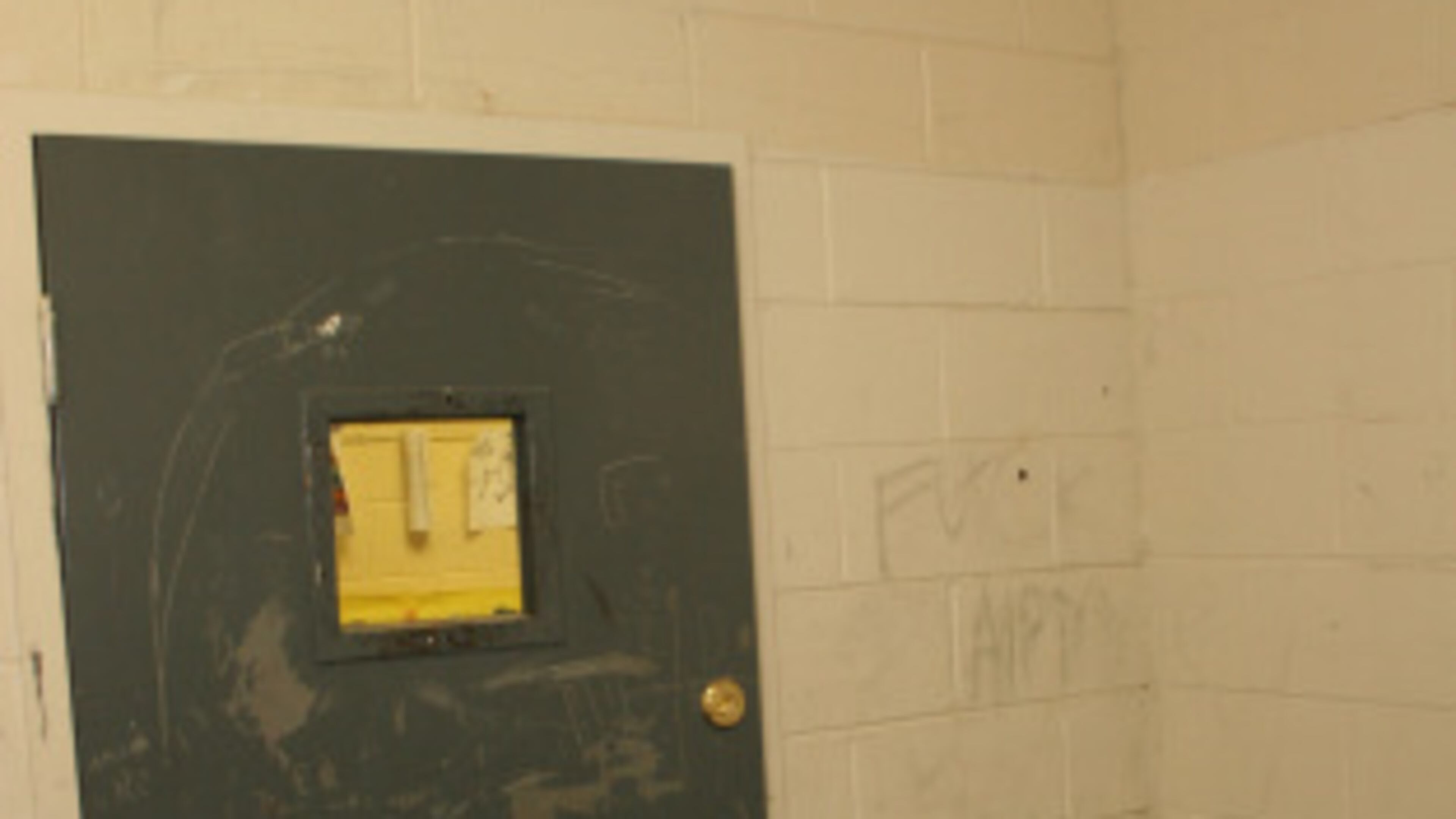 This metal door locked 13-year-old Jonathan King of Hall County into a seclusion room at one of Georgia’s “psychoeducational” programs for students with behavioral and emotional disabilities. Jonathan hanged himself in this room in 2004. (Photo by Gainesville Police Department.)