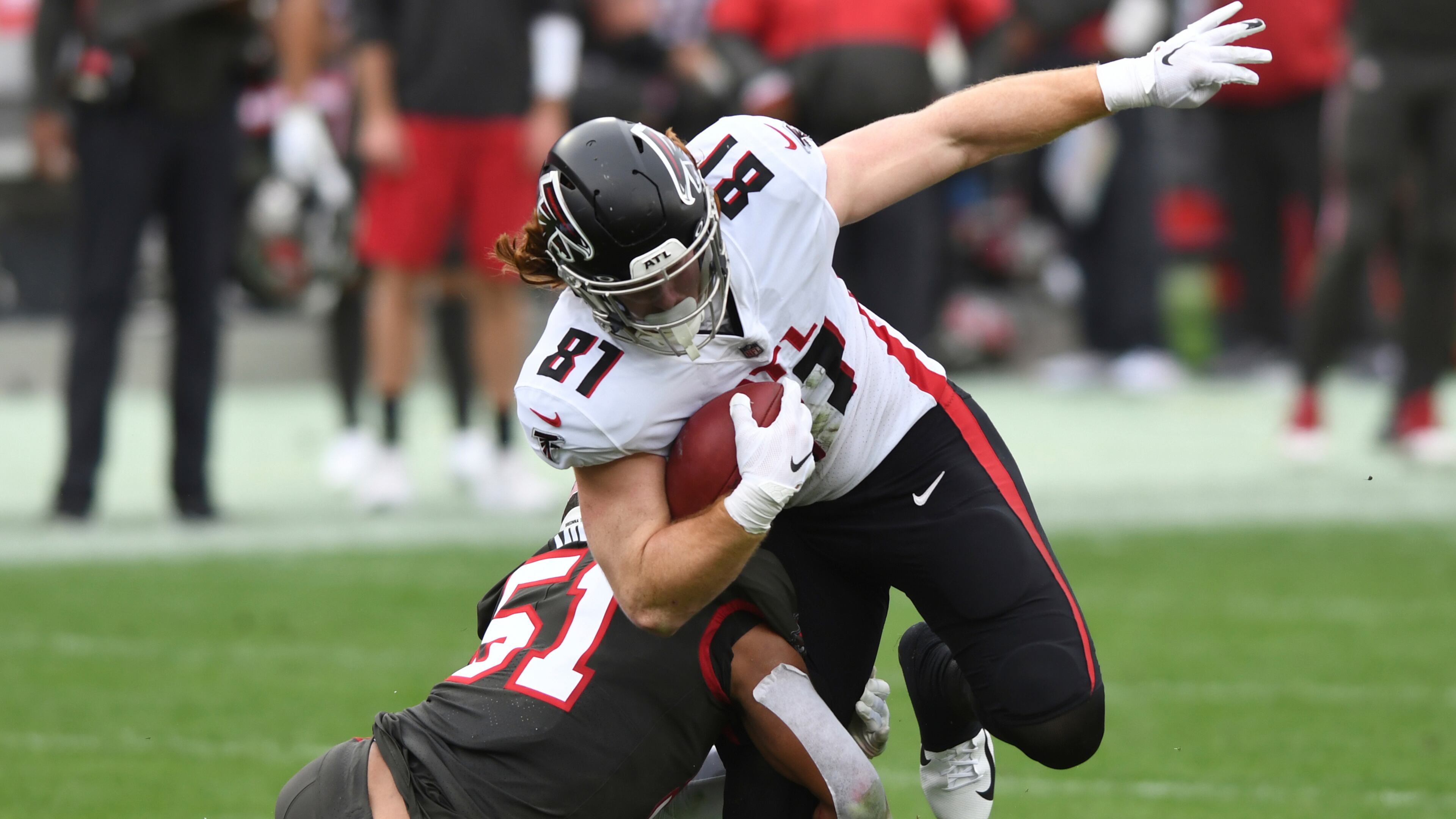 Atlanta Falcons tight end Hayden Hurst (81) eludes Tampa Bay Buccaneers linebacker Kevin Minter (51) during the second half Sunday, Jan. 3, 2021, in Tampa, Fla. (Jason Behnken/AP)