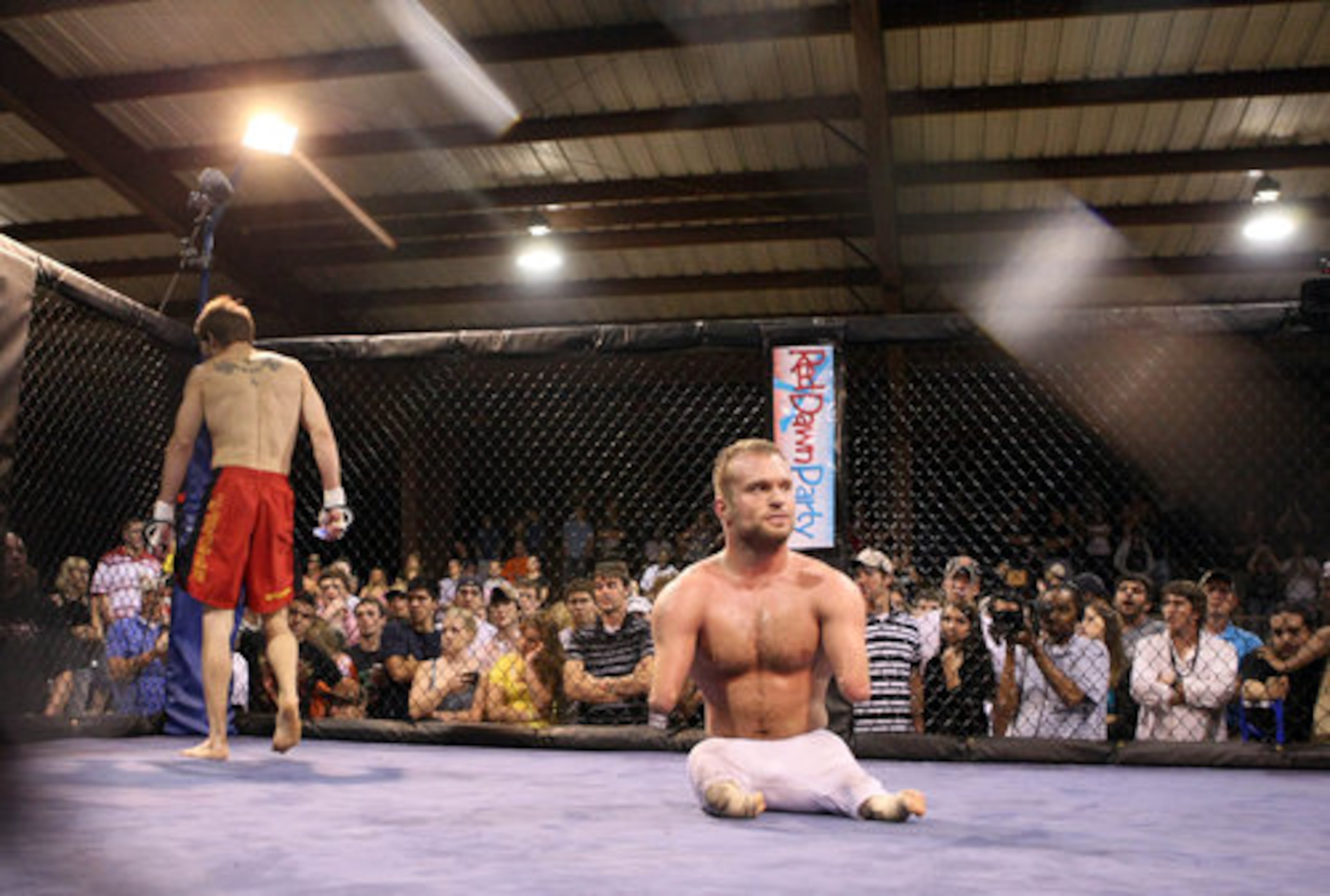 Maynard sits in center ring after the final bell sounded in the third and final round of his fight.
