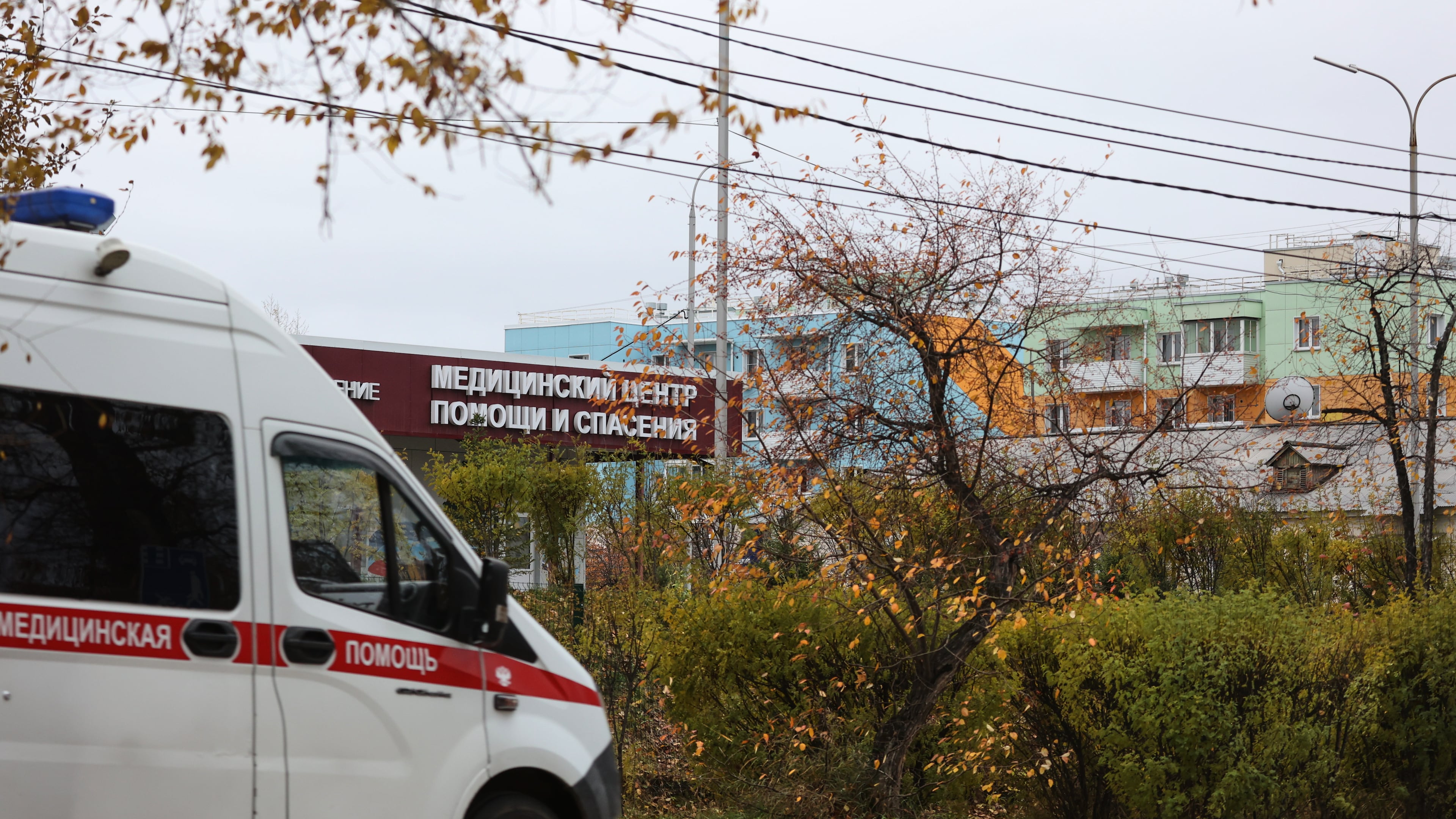 An ambulance drives past the medical center for treating infectious diseases, center, in Shelekhov, outside Irkutsk, Russia, on Thursday, Oct. 8, 2026. (AP Photo)