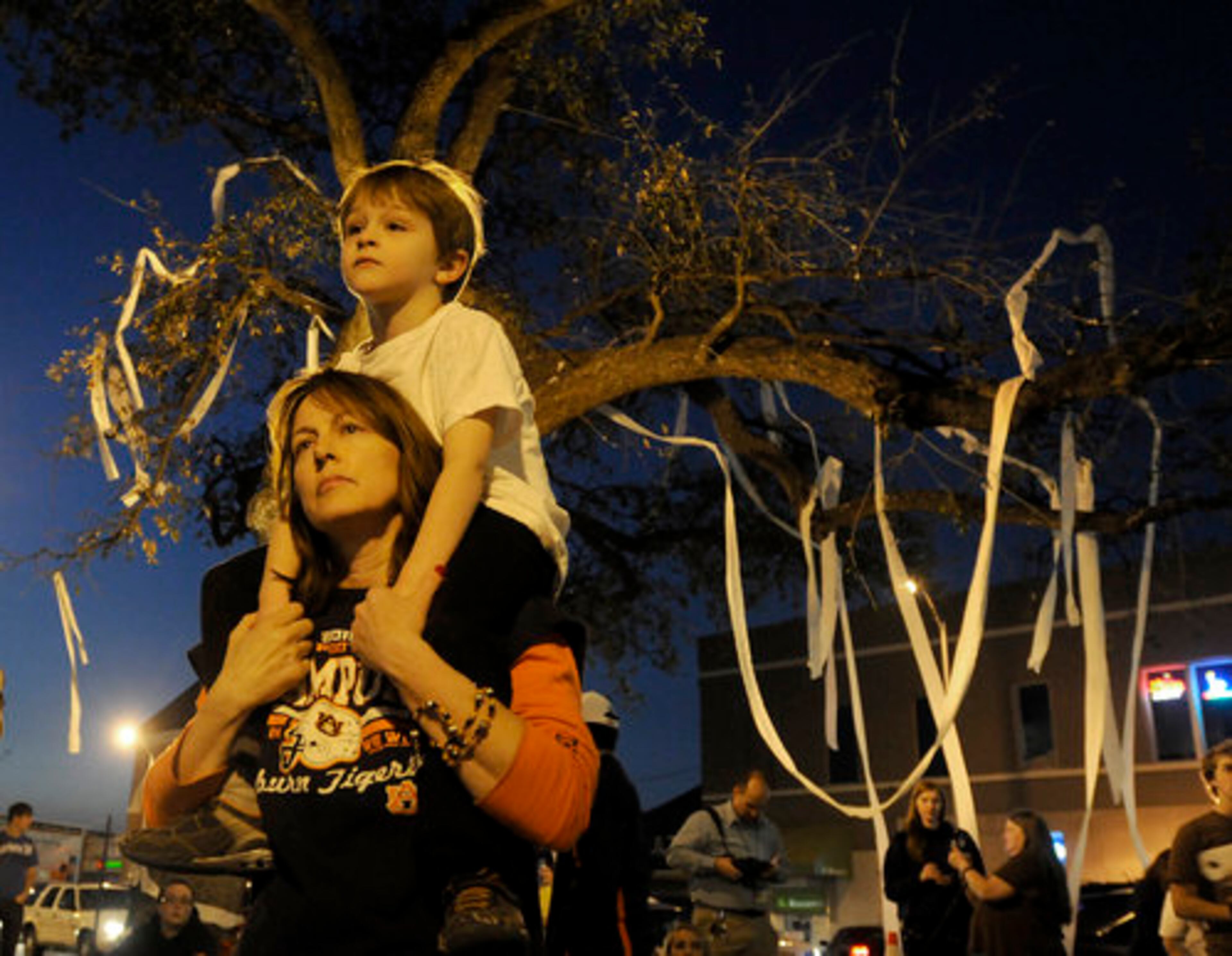 Earlier, supporters gathered to pay tribute to the live oak trees. Toni Rich and son Gabriel, 5, came to Toomer's Corner after word spread that the trees had been poisoned. Toomer's Corner has long been a site where Auburn fans celebrate big wins, including the football national championship on Jan. 10, 2011.