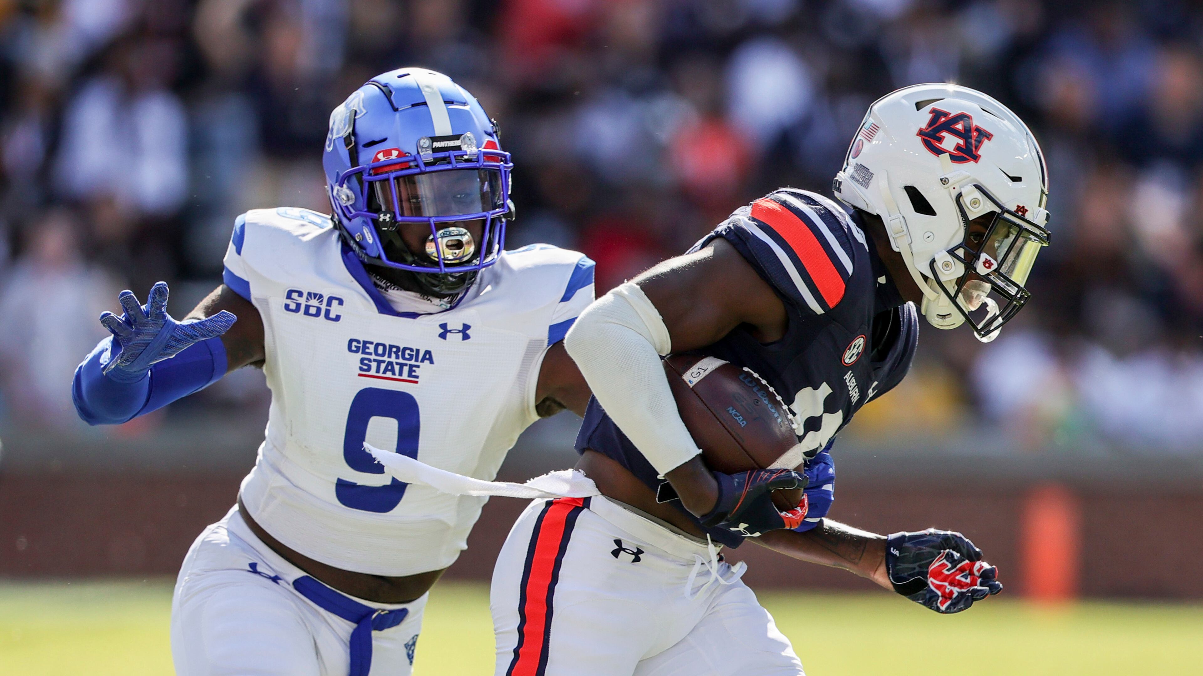 Auburn cornerback Nehemiah Pritchett (18) tries to get past Georgia State linebacker Jamil Muhammad (9) on a kick return during the first half of an NCAA football game Saturday, Sept. 25, 2021, in Auburn, Ala. (AP Photo/Butch Dill)