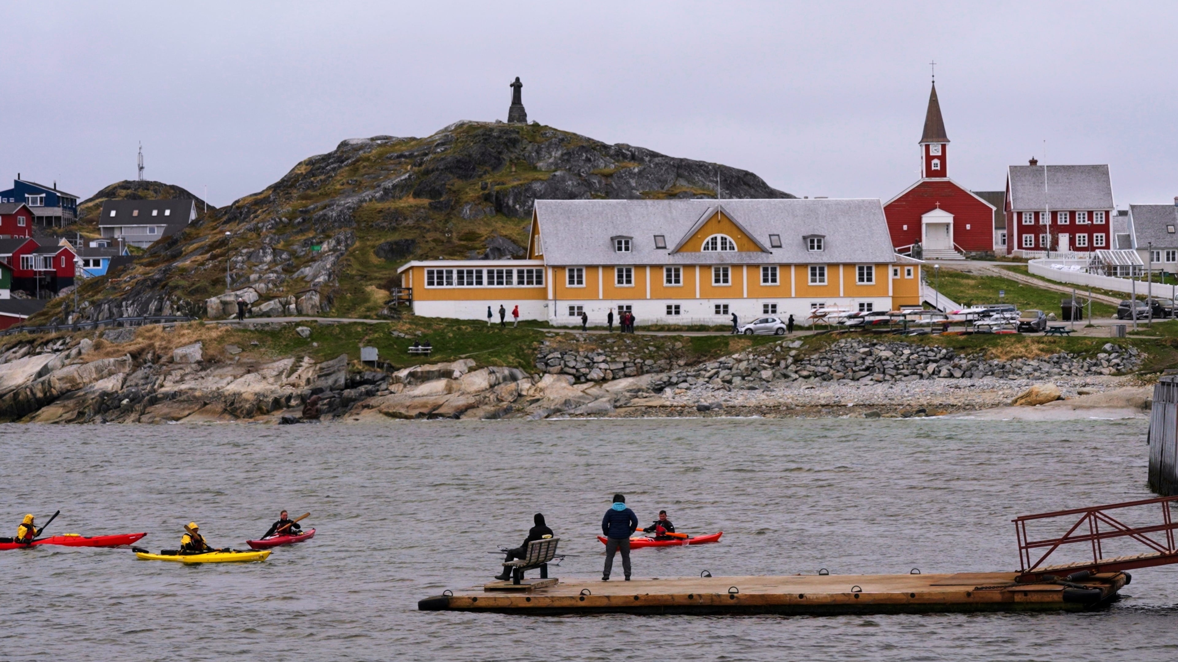 FILE - Tourists kayak at sea in front of Nuuk Cathedral in Nuuk, Greenland, June 16, 2025. (AP Photo/Kwiyeon Ha, File)