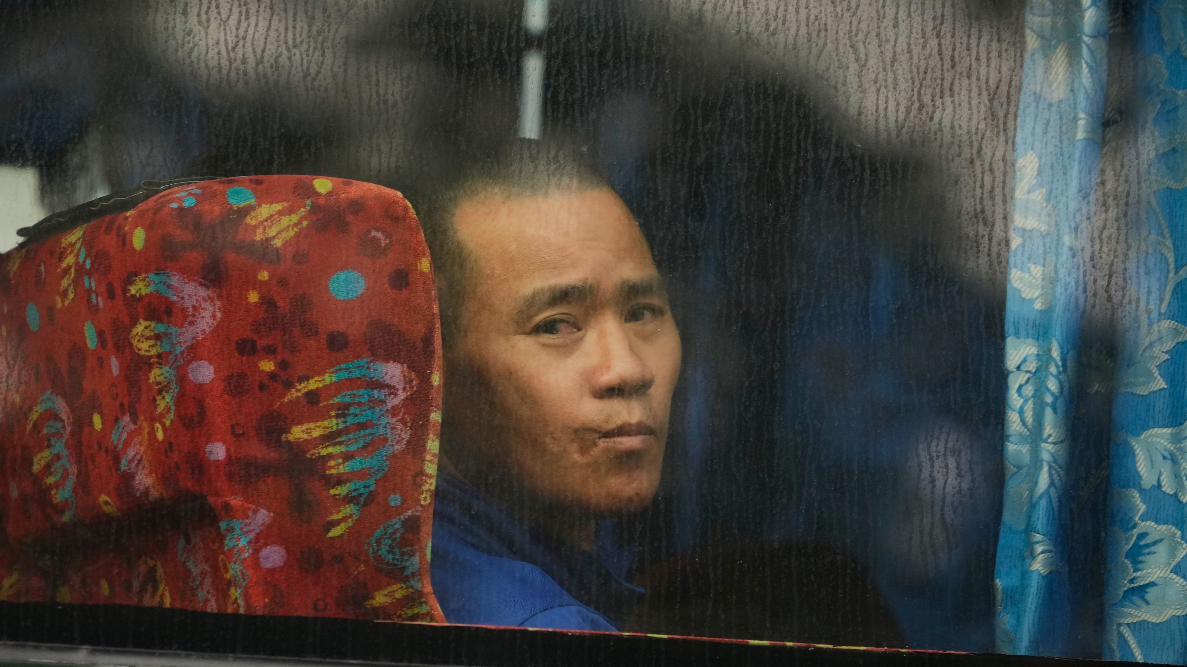 One of Myanmar nationals looks out from a bus in Manjung, Perak state of Malaysia, on Tuesday, Sept. 29, 2026. (AP Photo/Vincent Thian)
