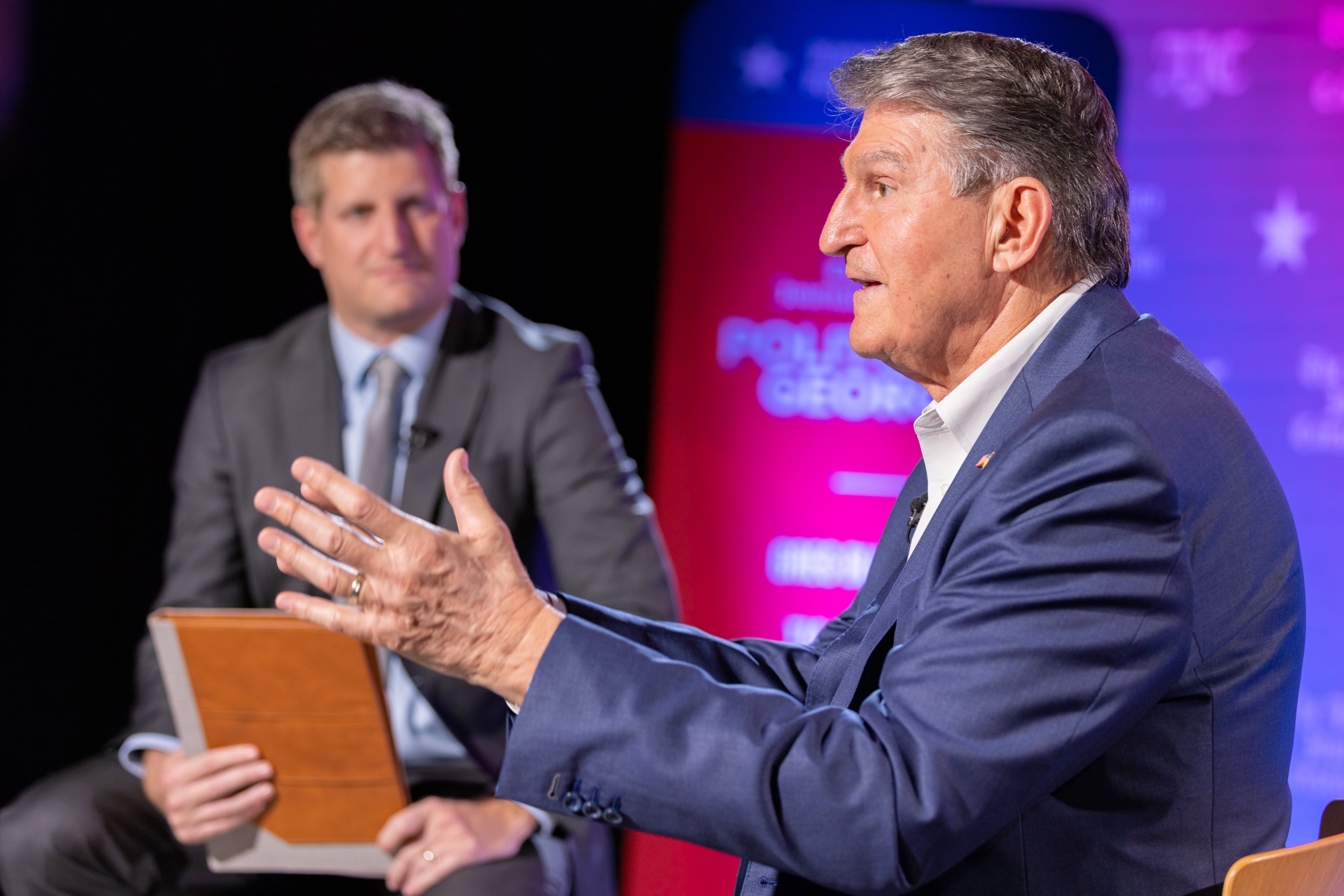 AJC reporter Greg Bluestein (background) interviews U.S. Sen Joe Manchin, D-West Virginia, for an AJC Town Hall at Georgia State University in Atlanta on Friday, January 26, 2024. (Arvin Temkar / arvin.temkar@ajc.com)