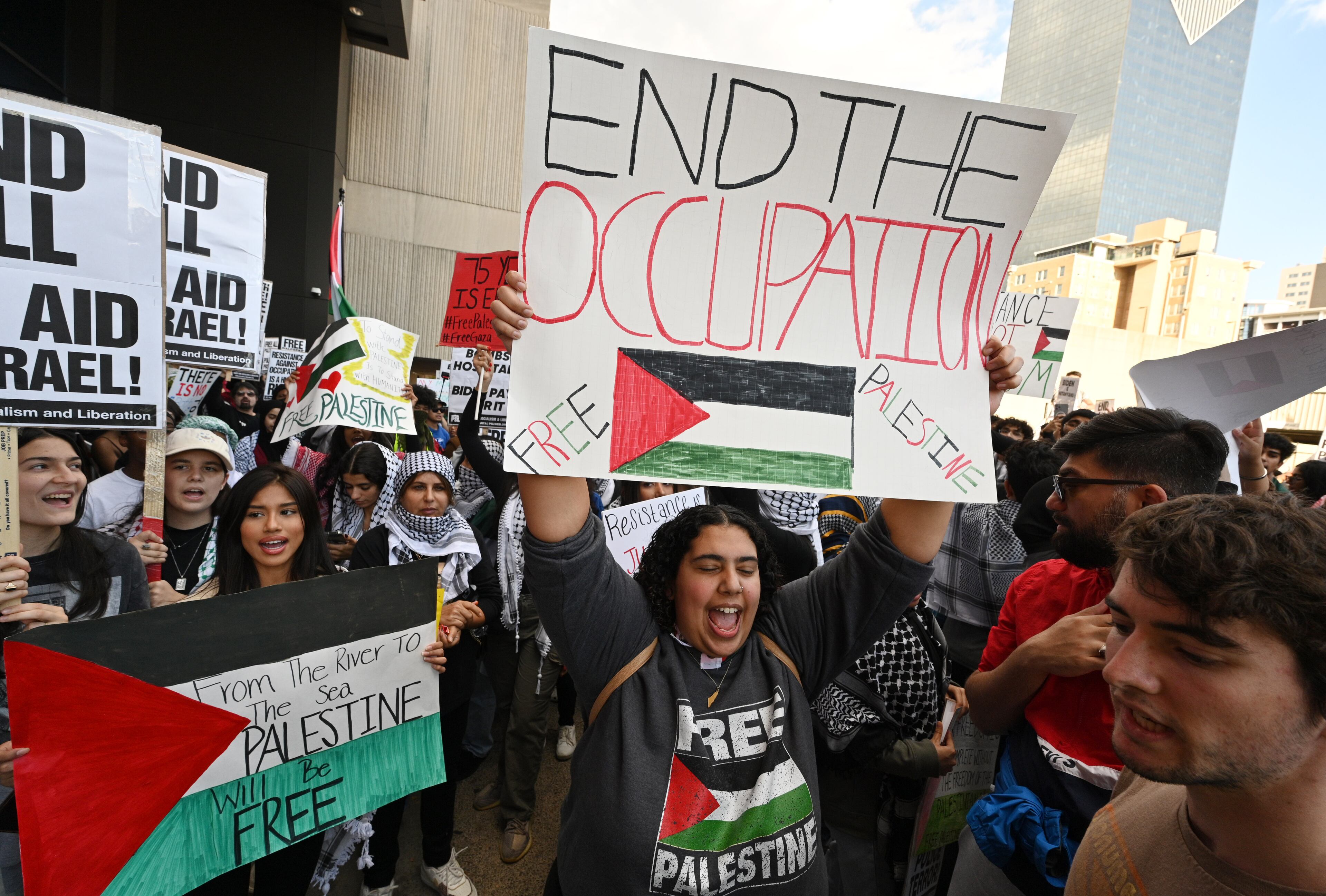 Pro-Palestinian supporters hold signs during a rally in front of the CNN Center, Friday, October 20, 2023, in Atlanta. Hundreds gathered in downtown Atlanta to march in support of Palestine. (Hyosub Shin / Hyosub.Shin@ajc.com)