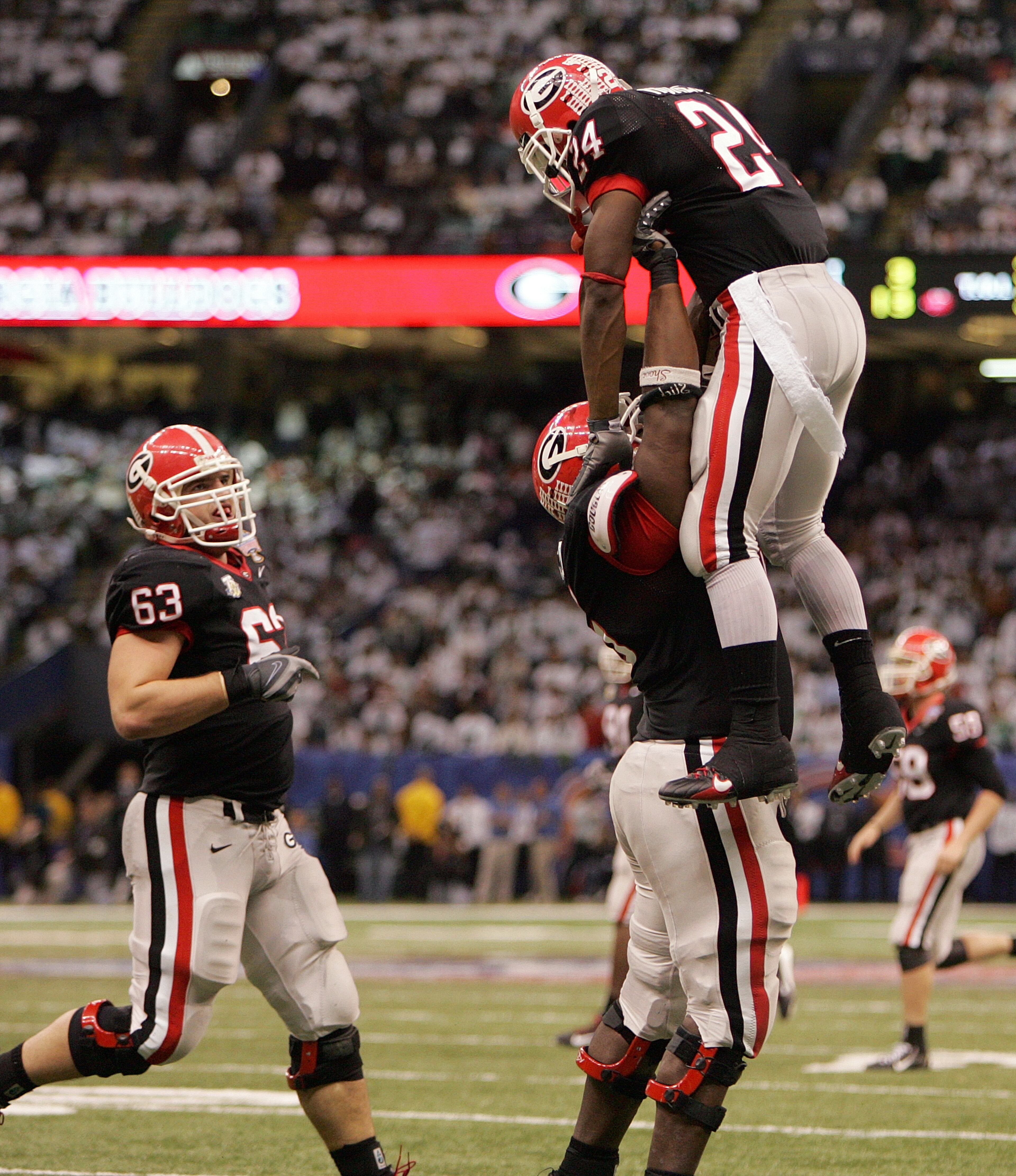 Georgia center Fernando Velasco (75) lifts Georgia tailback Knowshon Moreno (24) up in the air to celebrate Moreno's second TD of the Sugar Bowl on Jan. 1, 2008 in New Orleans. BRANT SANDERLIN / Staff