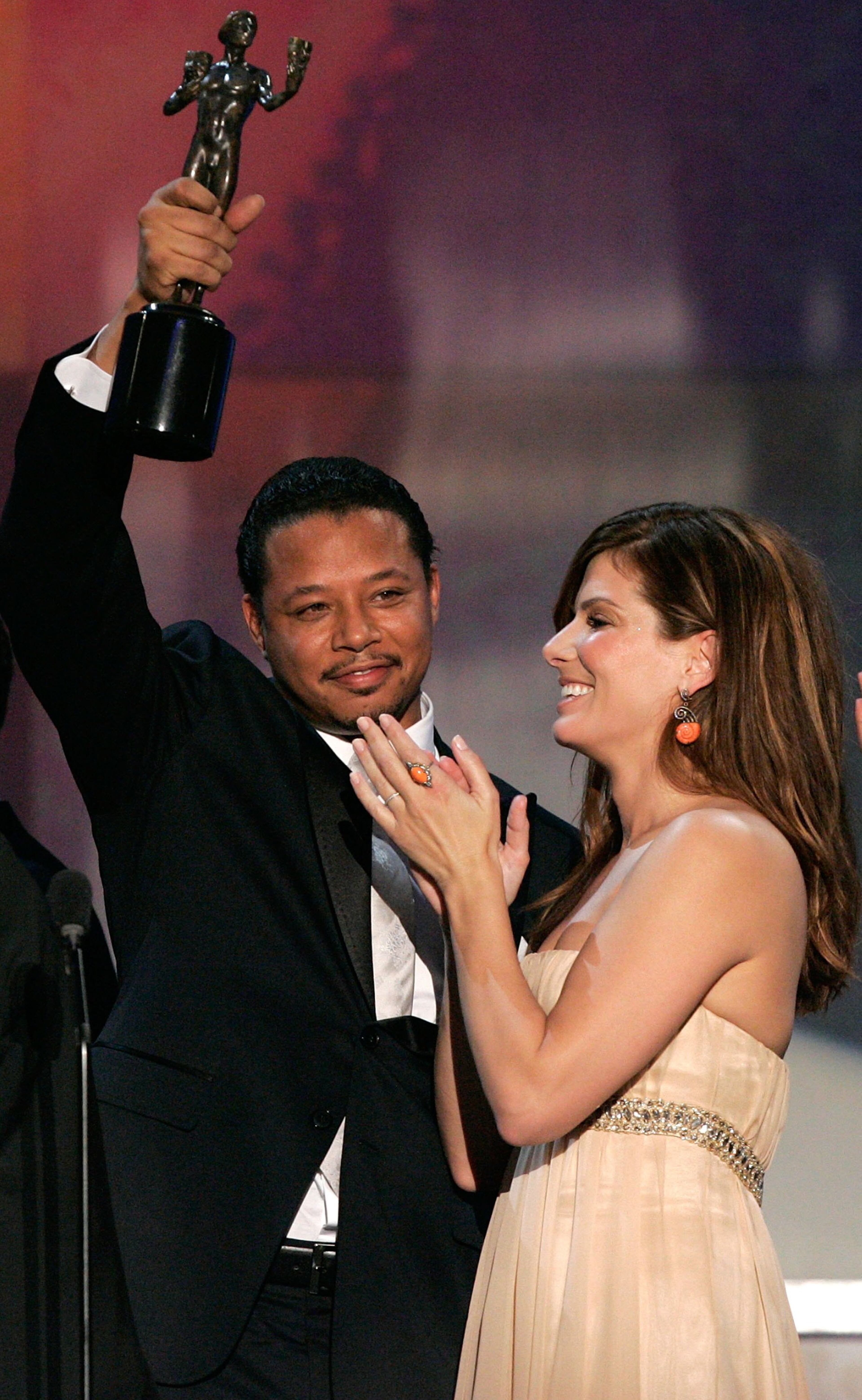 Actor Terrence Howard and Sandra Bullock accept the Outstanding Cast of a Motion Picture award onstage during the 12th Annual Screen Actors Guild Awards held at the Shrine Auditorium on January 29, 2006 in Los Angeles, California. (Photo by Kevin Winter/Getty Images)