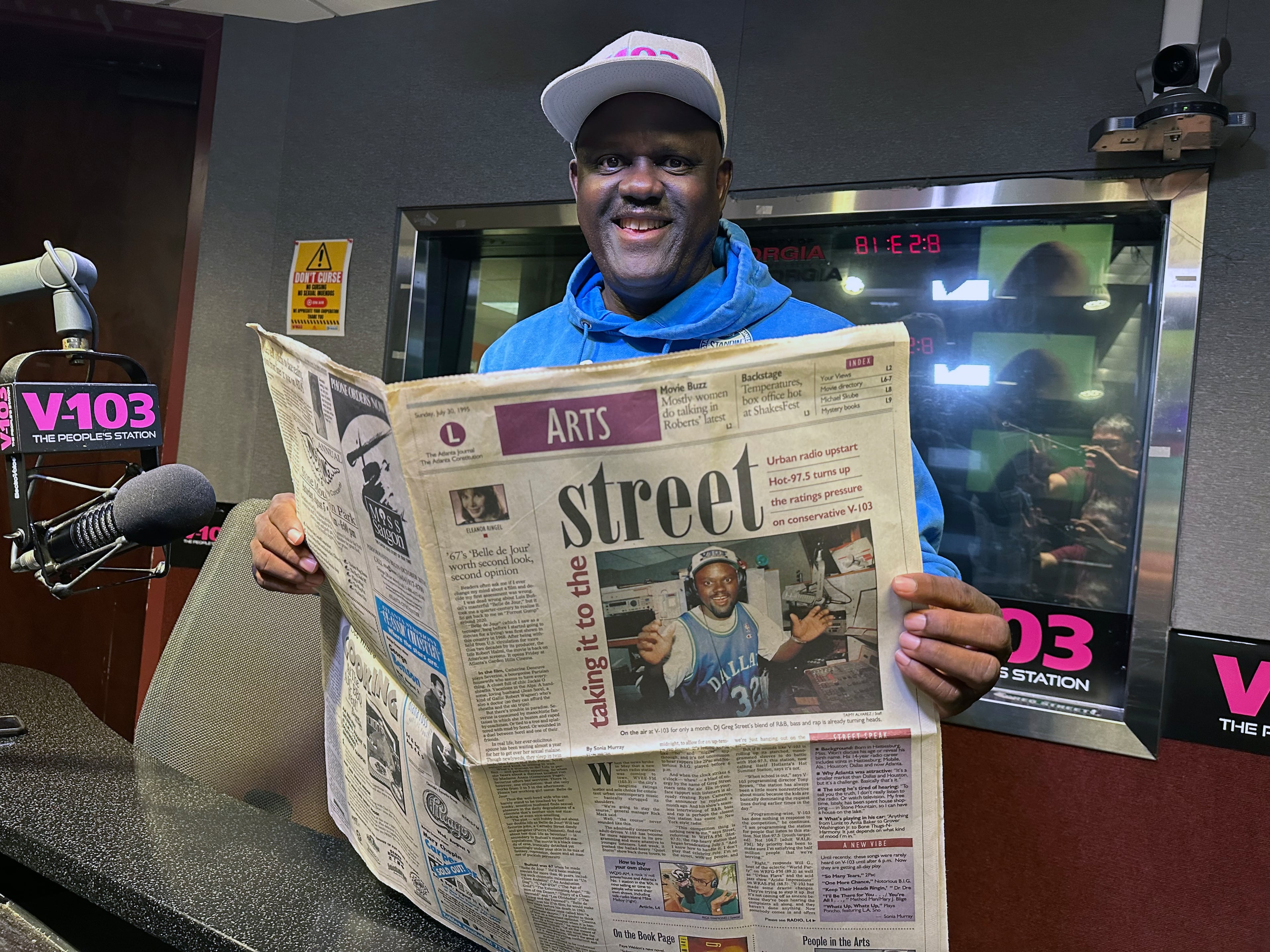 Greg Street at V-103 studios with the very first article in The Atlanta Journal-Constitution written about him when he arrived in 1995. (Rodney Ho/AJC)