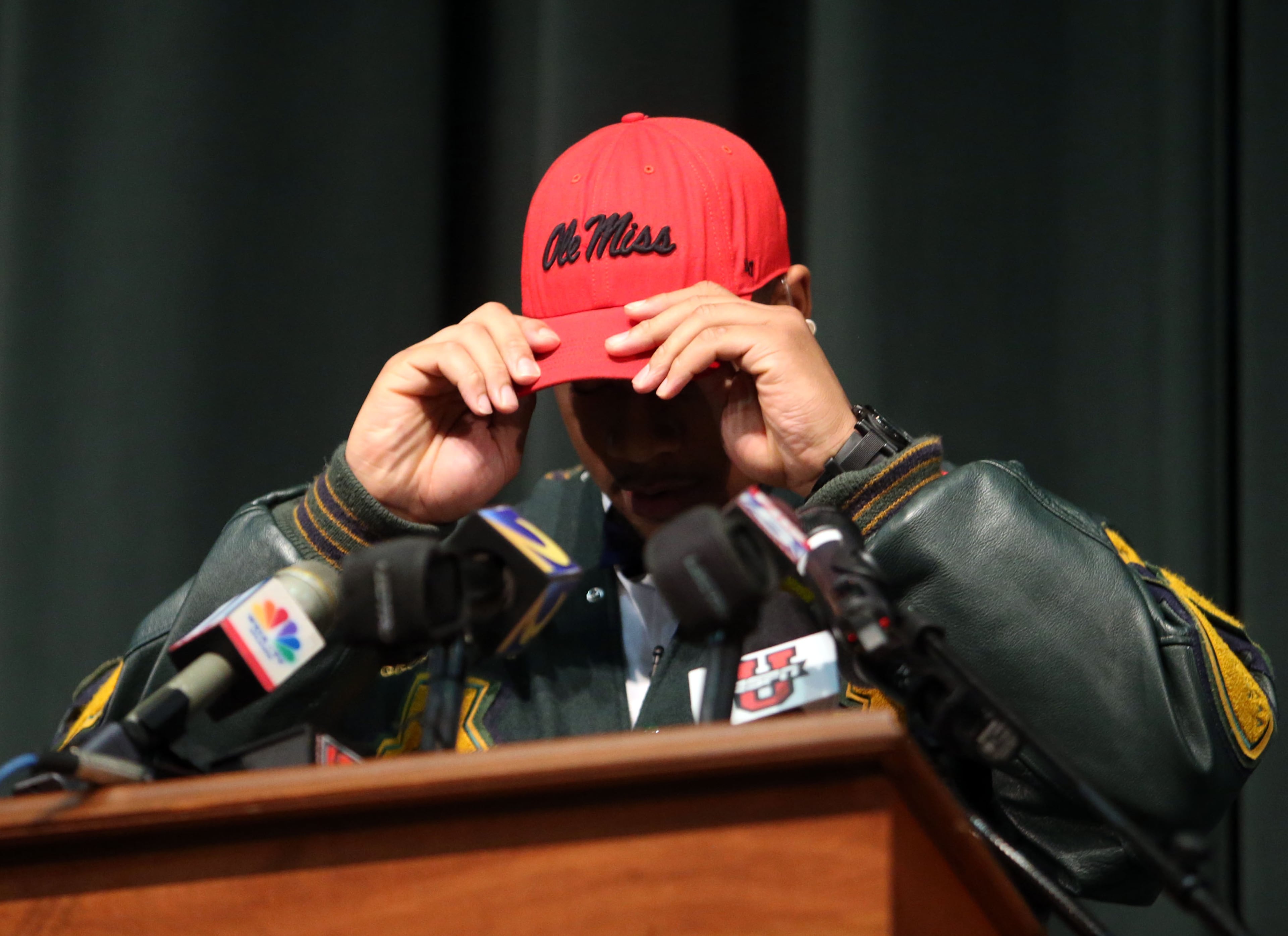 Grayson defensive end Robert Nkemdiche puts on an Ole Miss hat as he commits to the school.