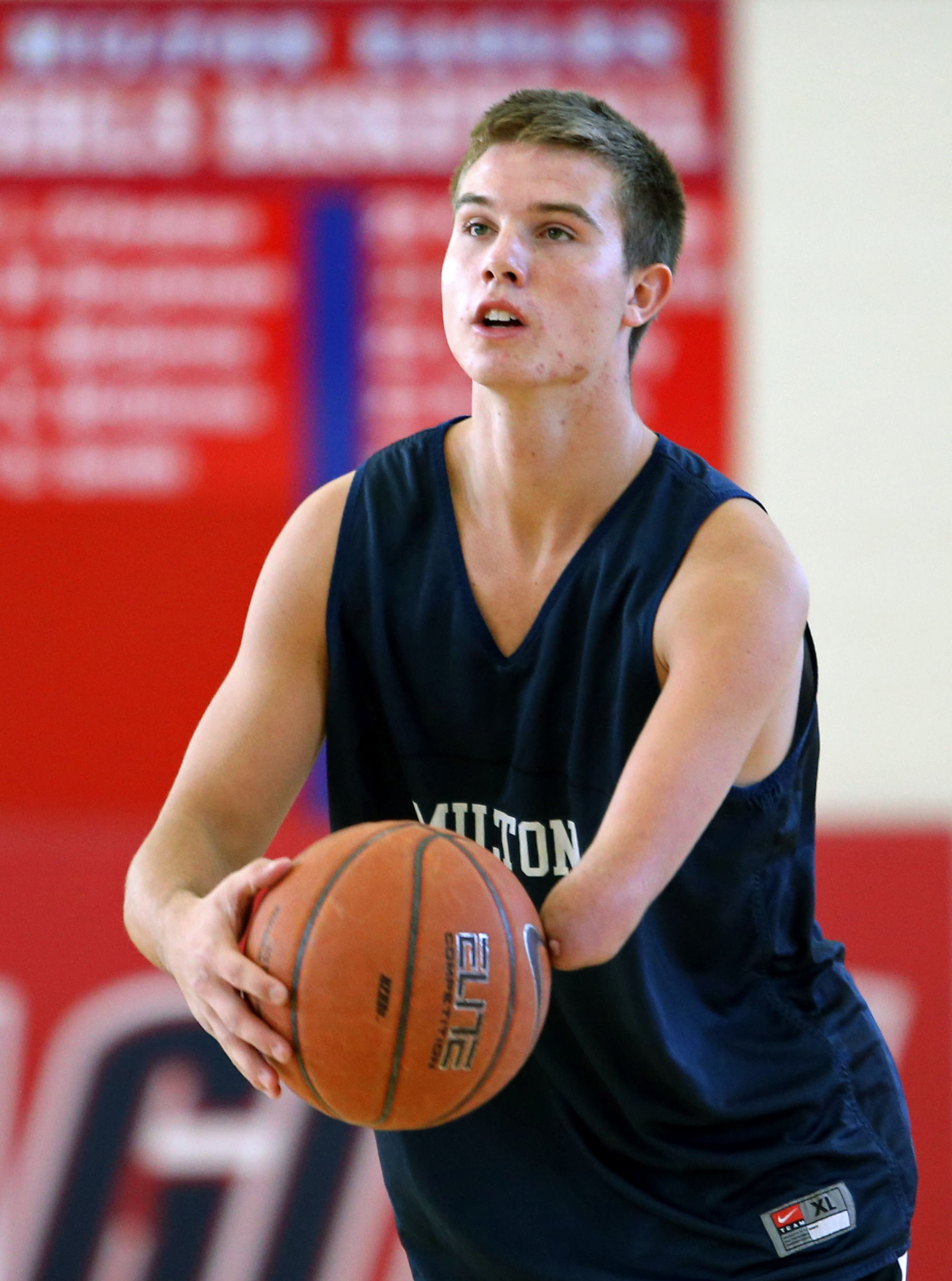 Zach Hodskins works out with his father Bob (not pictured) in Milton's gymnasium Thursday afternoon in Milton, Ga., October 24, 2013. Hodskins, who was born without the lower half of his left arm, recently committed to the University of Florida as a preferred walk-on. Hodskins is recovering from a sprained ankle but he expects to start the upcoming high school basketball season. JASON GETZ / JGETZ@AJC.COM